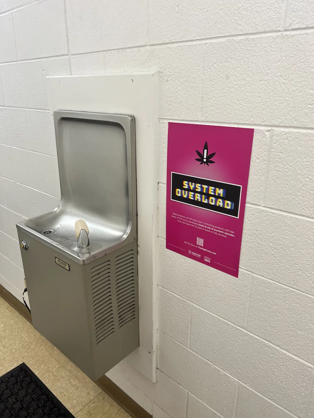 Health poster beside a school drinking fountain