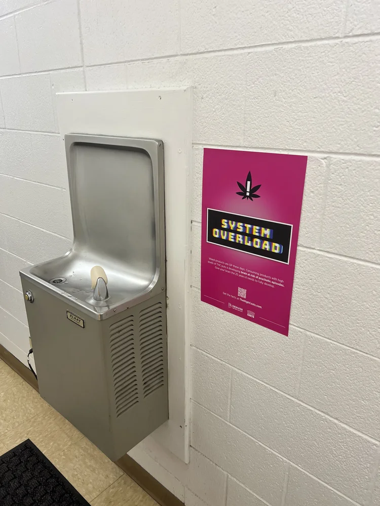 Health poster beside a school drinking fountain