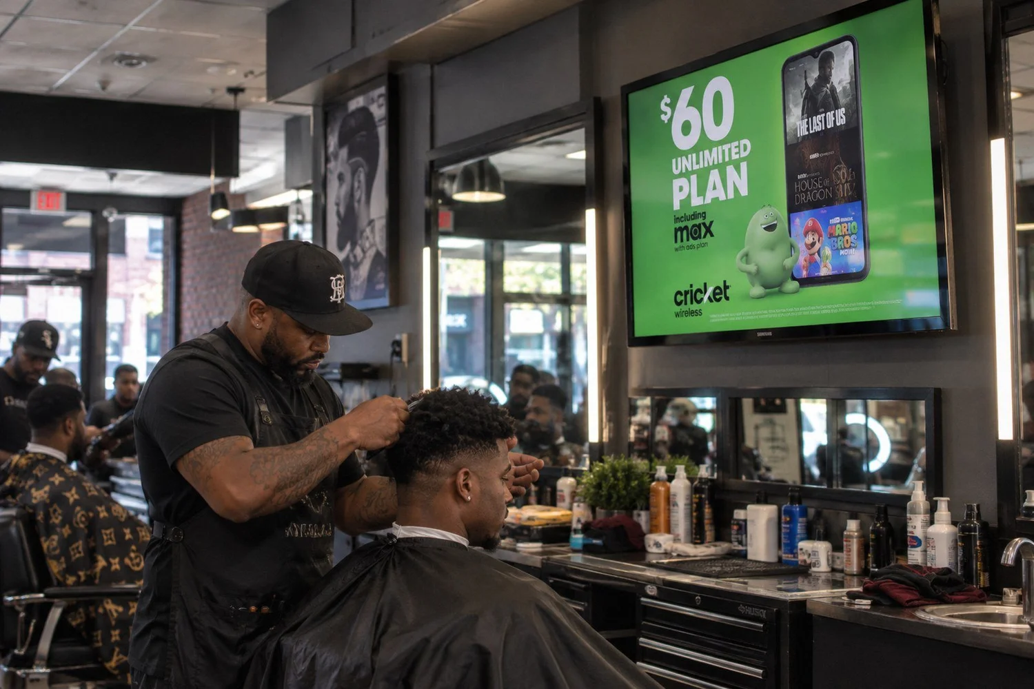 Prepaid wireless plan ad on a wall screen inside a busy barbershop