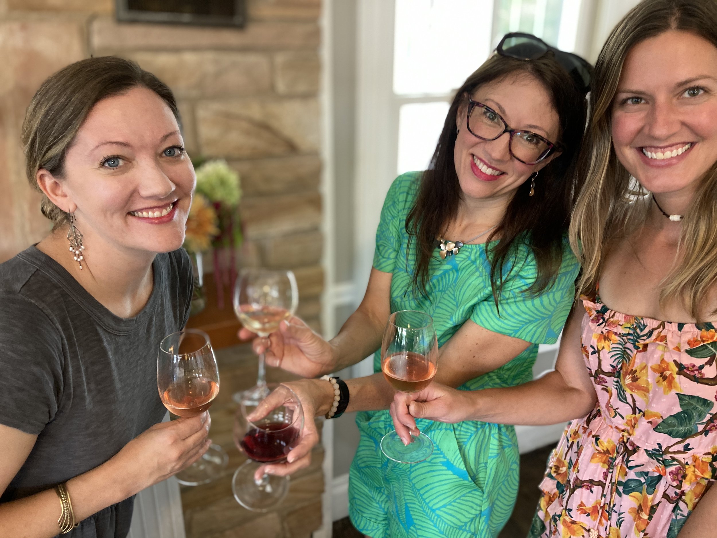 Three friends enjoying a wine tasting experience at Roberts Ranch Vineyards