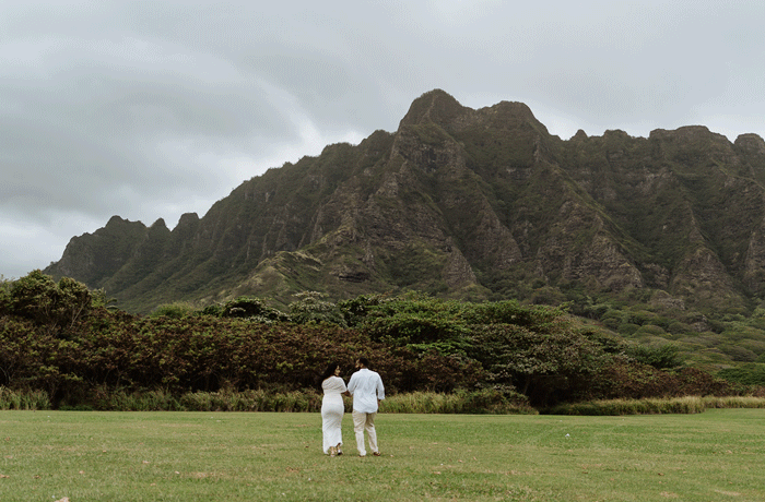 A romantic, moody engagement session on Oahu’s North Shore near Kualoa Ranch, capturing raw love against Hawaii’s dramatic coastal beauty.
