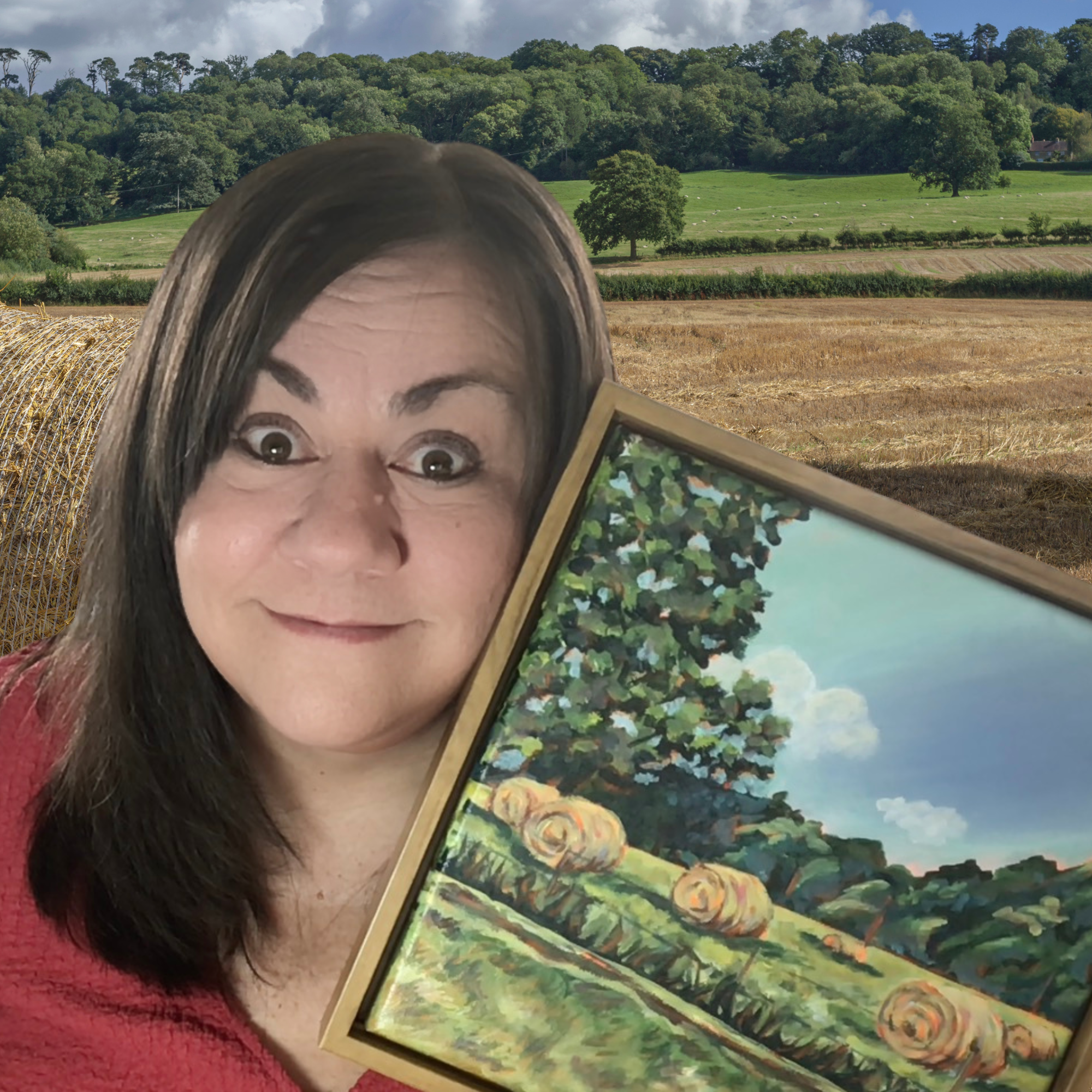 A woman with dark hair and a red shirt holding a framed painting of a rural landscape with trees and rolled hay bales.