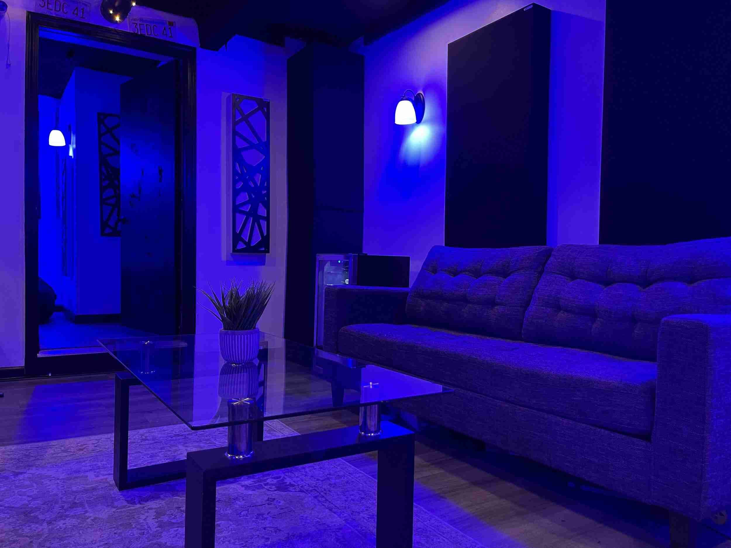 The recording booth entrance of the music studio, acoustic foam panels for soundproofing and the listening couch.