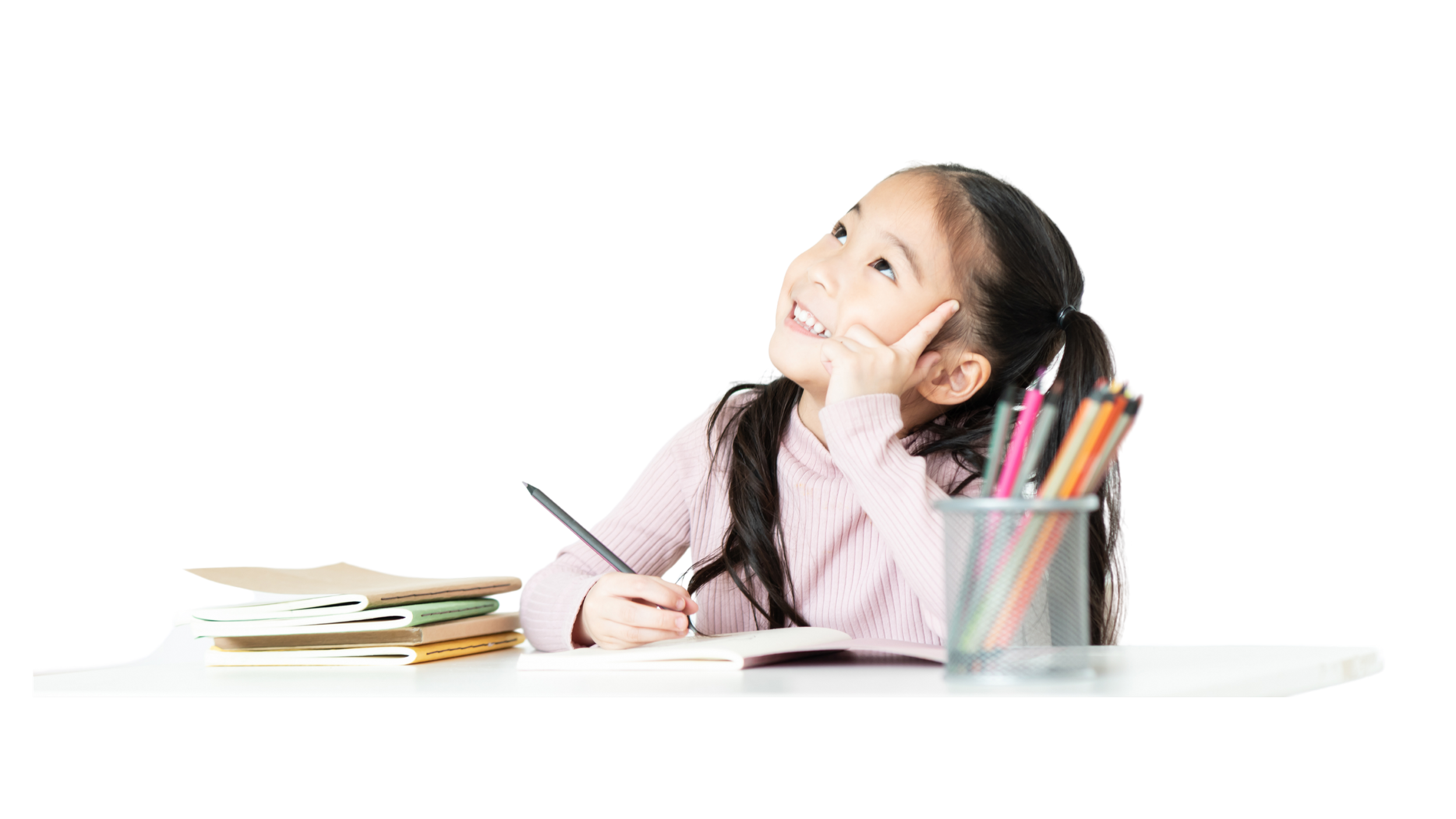 A young girl sitting at a desk, smiling and looking upwards, surrounded by notebooks and a cup filled with colored pencils.