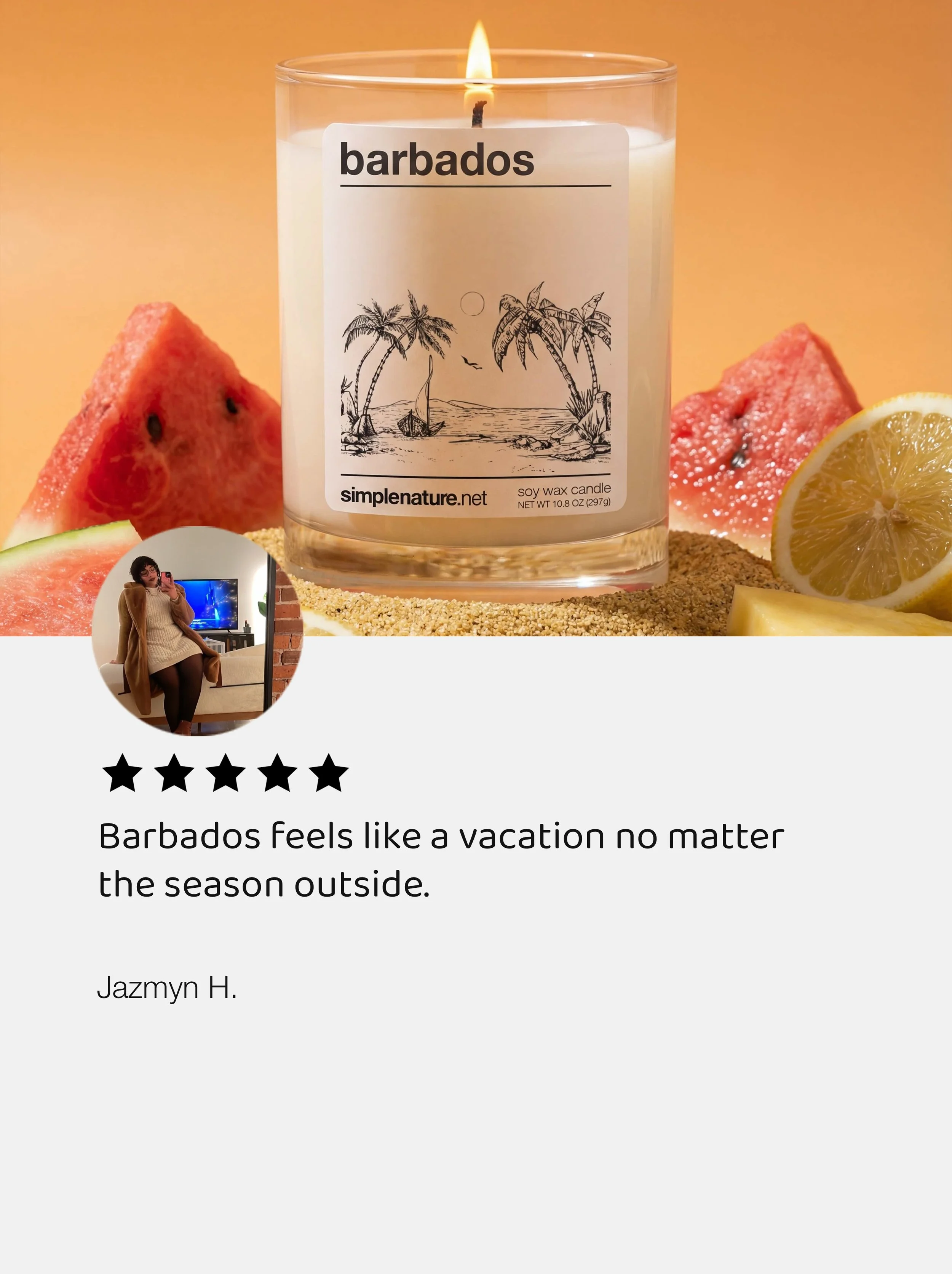 A candle named Barbados with a beach scene illustration on its label, surrounded by slices of watermelon and lemon, on a sandy surface with a warm background. A person in a beige coat taking a mirror selfie is visible in a small inset photo.