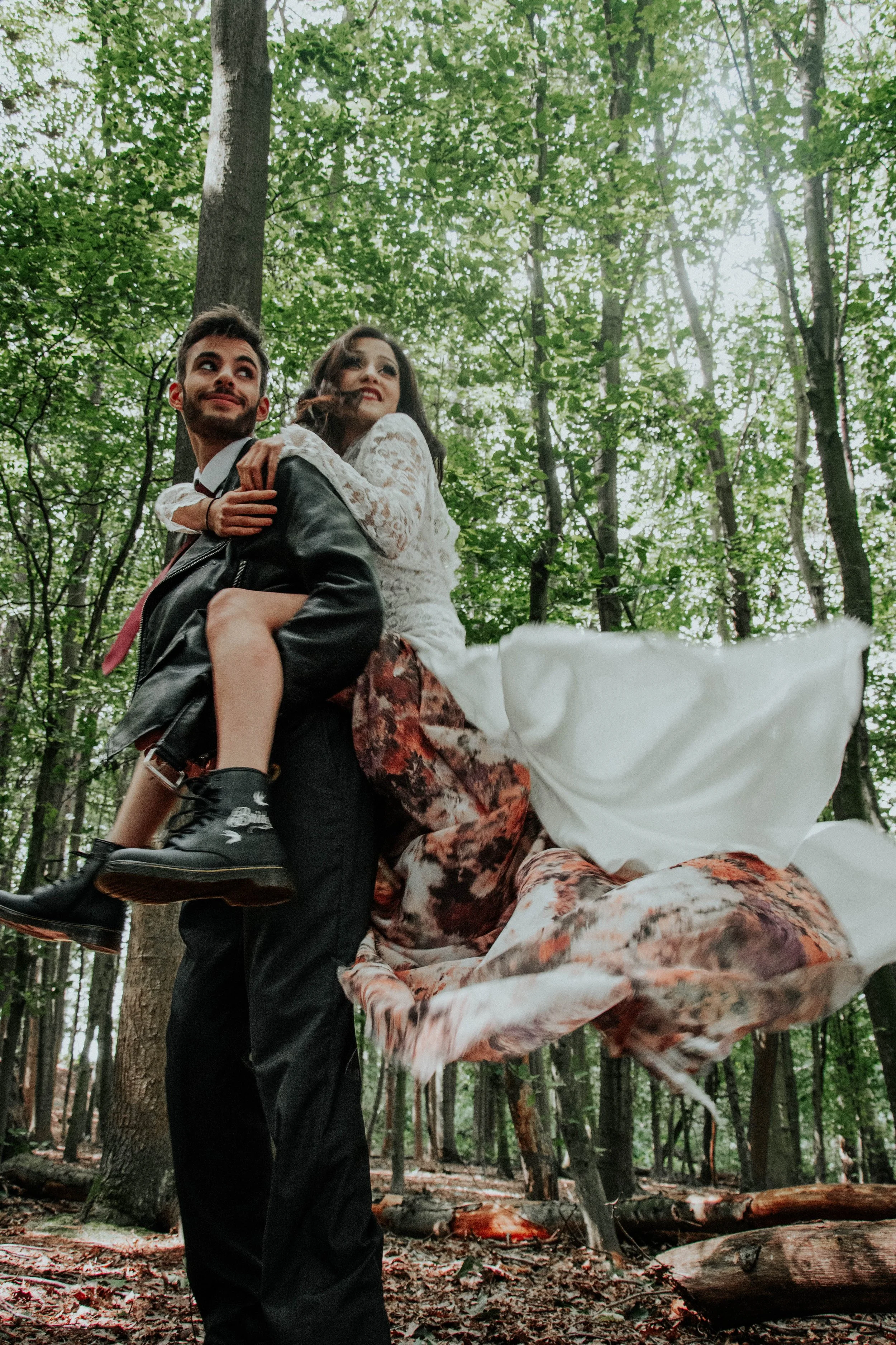 Bride being spun on the back of the groom after wedding ceremony