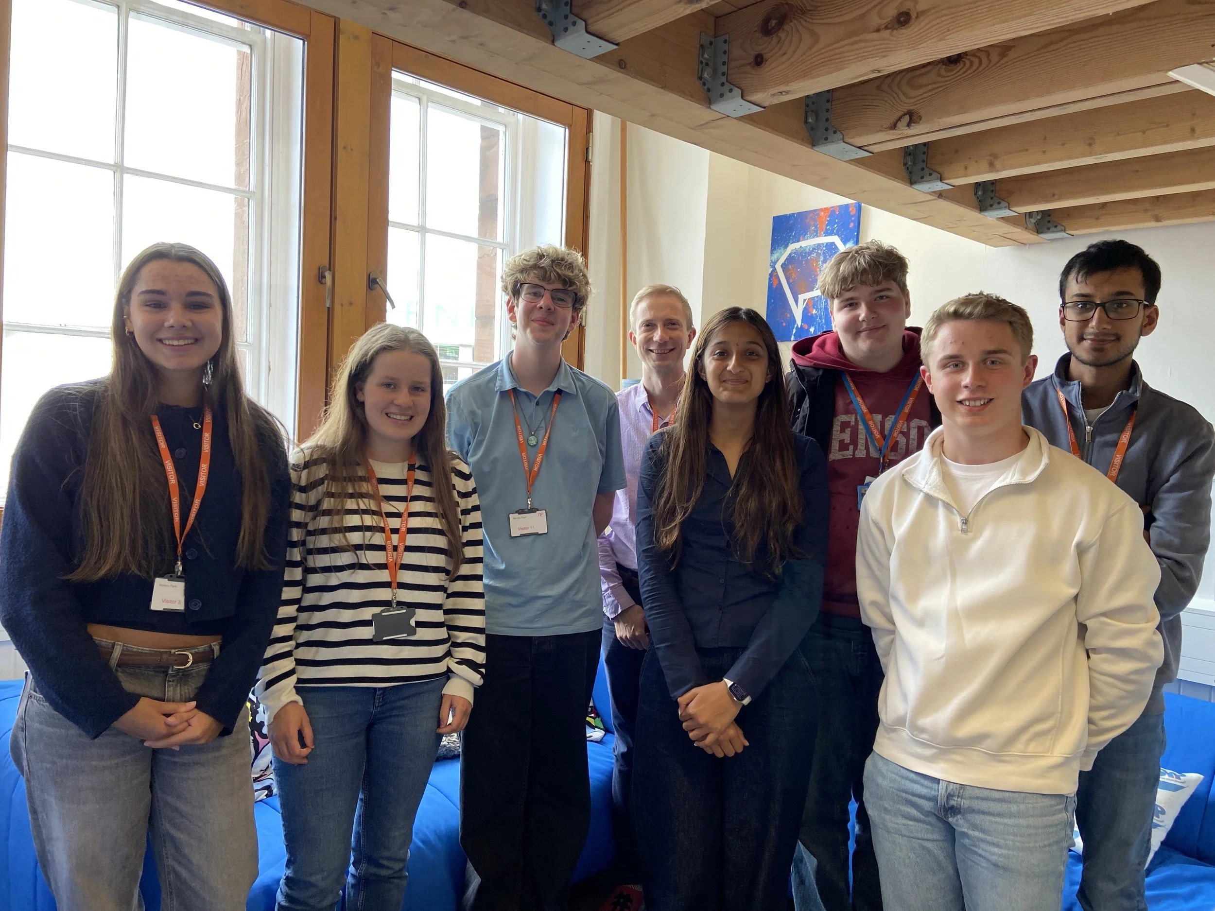 A group of seven MSYPs and an adult standing next to each other at the SYP Office