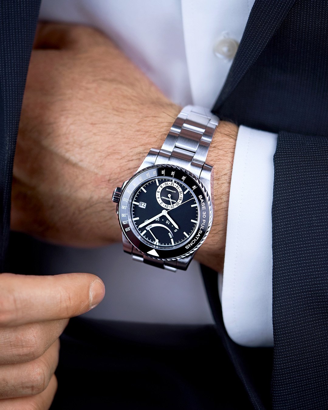 Male in evening formal look and black dial pulsometer men’s luxury watch, reaching into his chest pockets