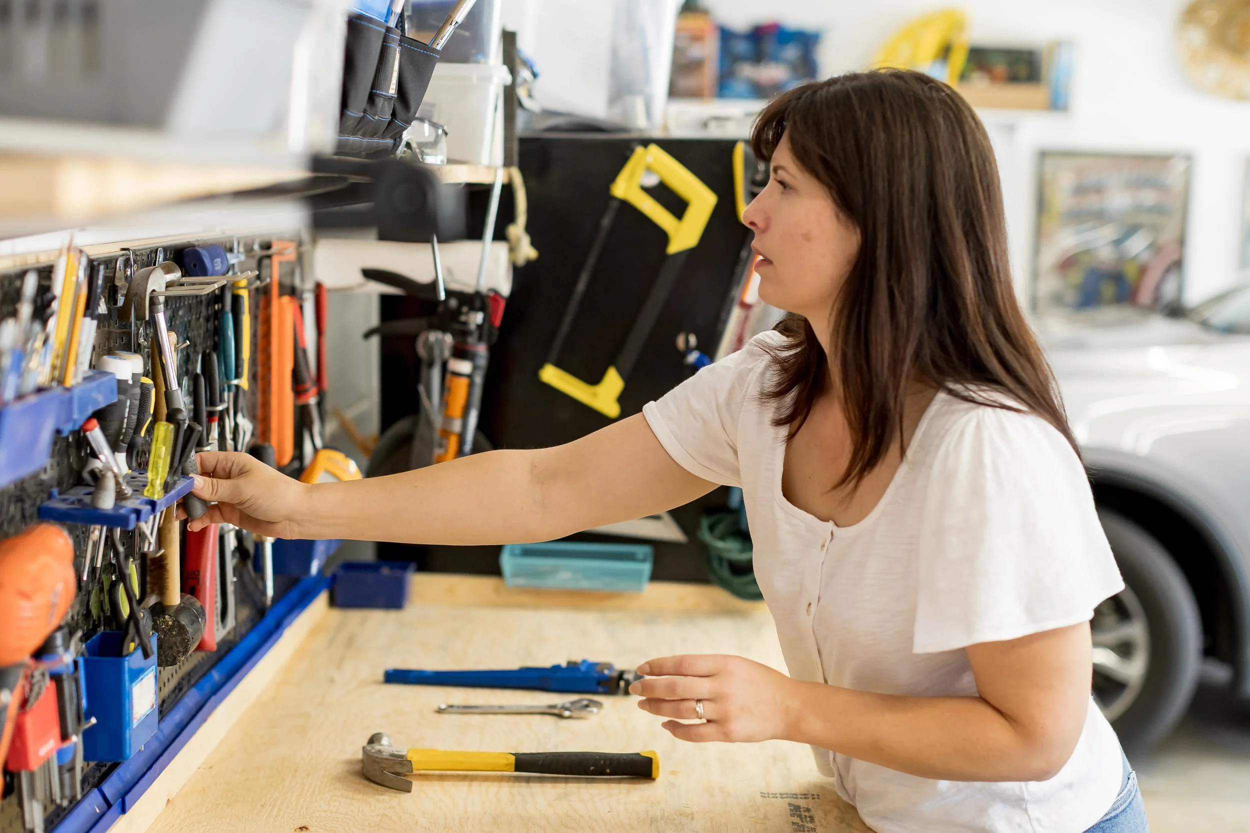 Professional organizer setting up effective storage solutions in a garage.
