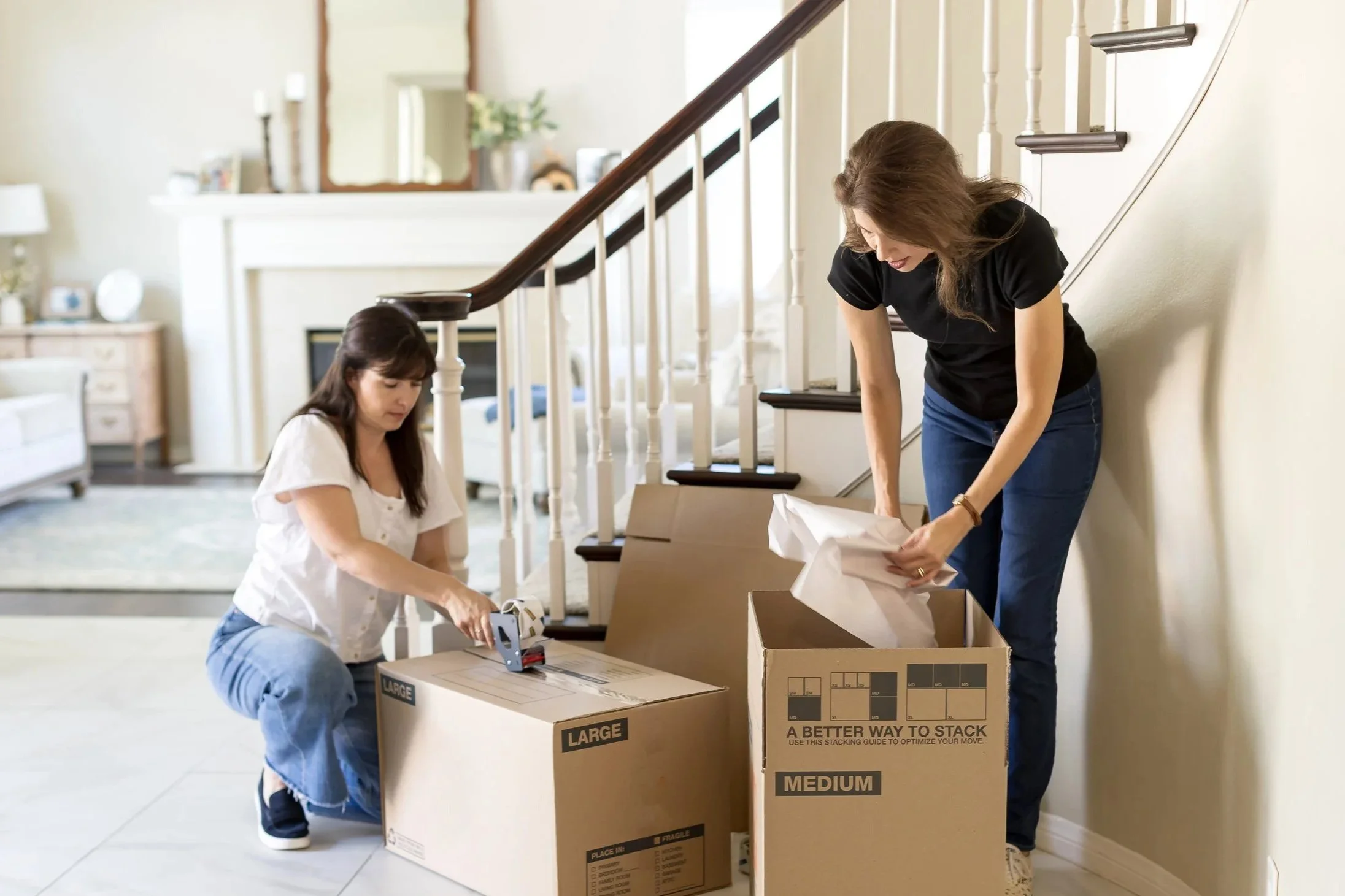 Professional organizers helping client pack up house for moving day.