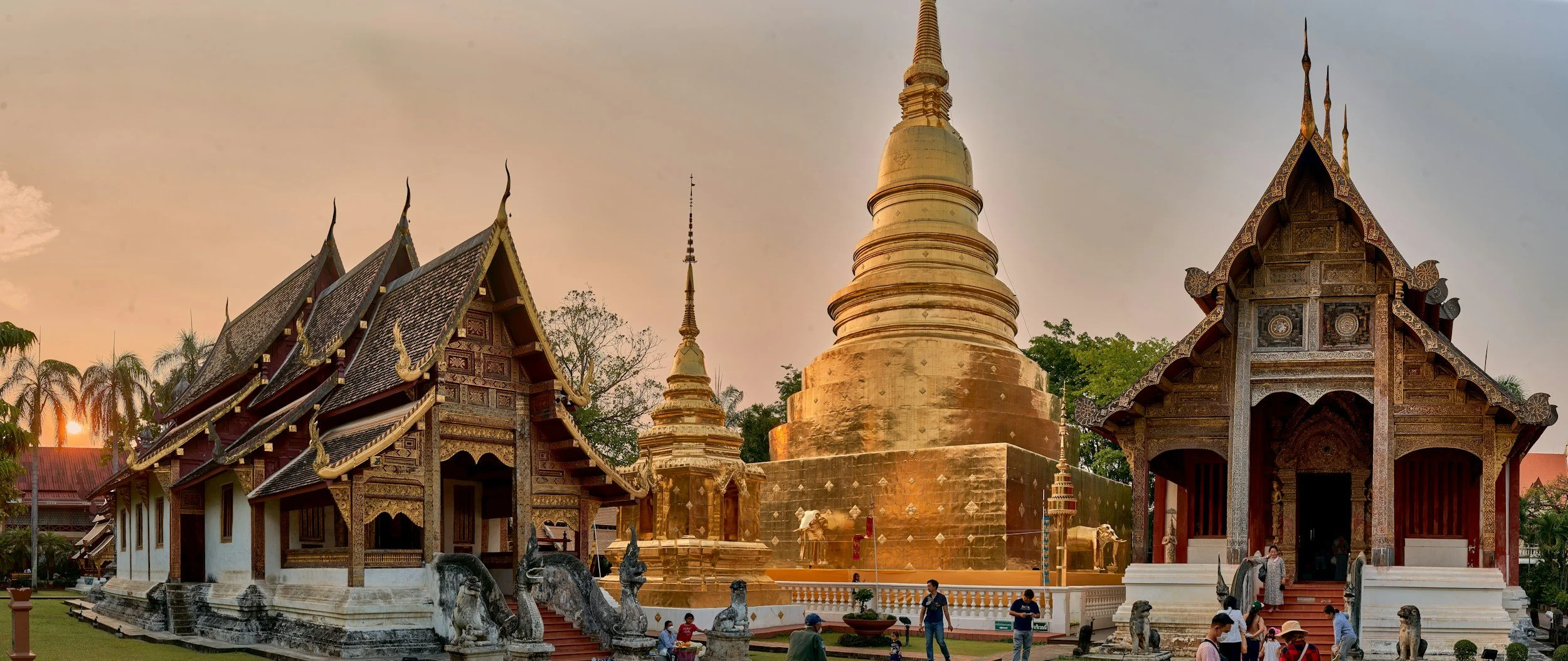 Wat Phra Singh, a Buddhist temple complex in Chiang Mai, Thailand, featuring traditional Thai architecture and a golden stupa at sunset.