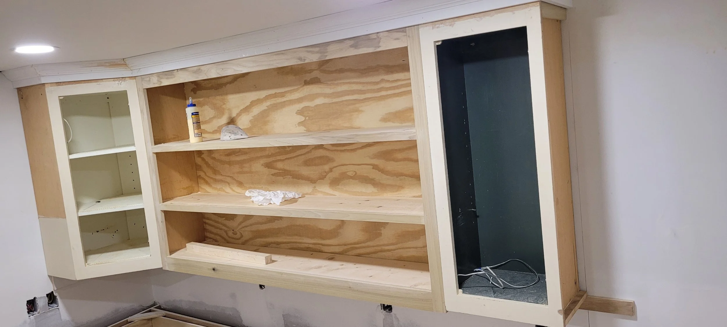  This is the kitchen cabinets at 1007 Grayland getting close to finished. Our carpenter has built cabinets to match the ones I salvaged from Architectural Salvage and is giving them a coat of cabinet paint inside and out. Then a clear coat of paint w