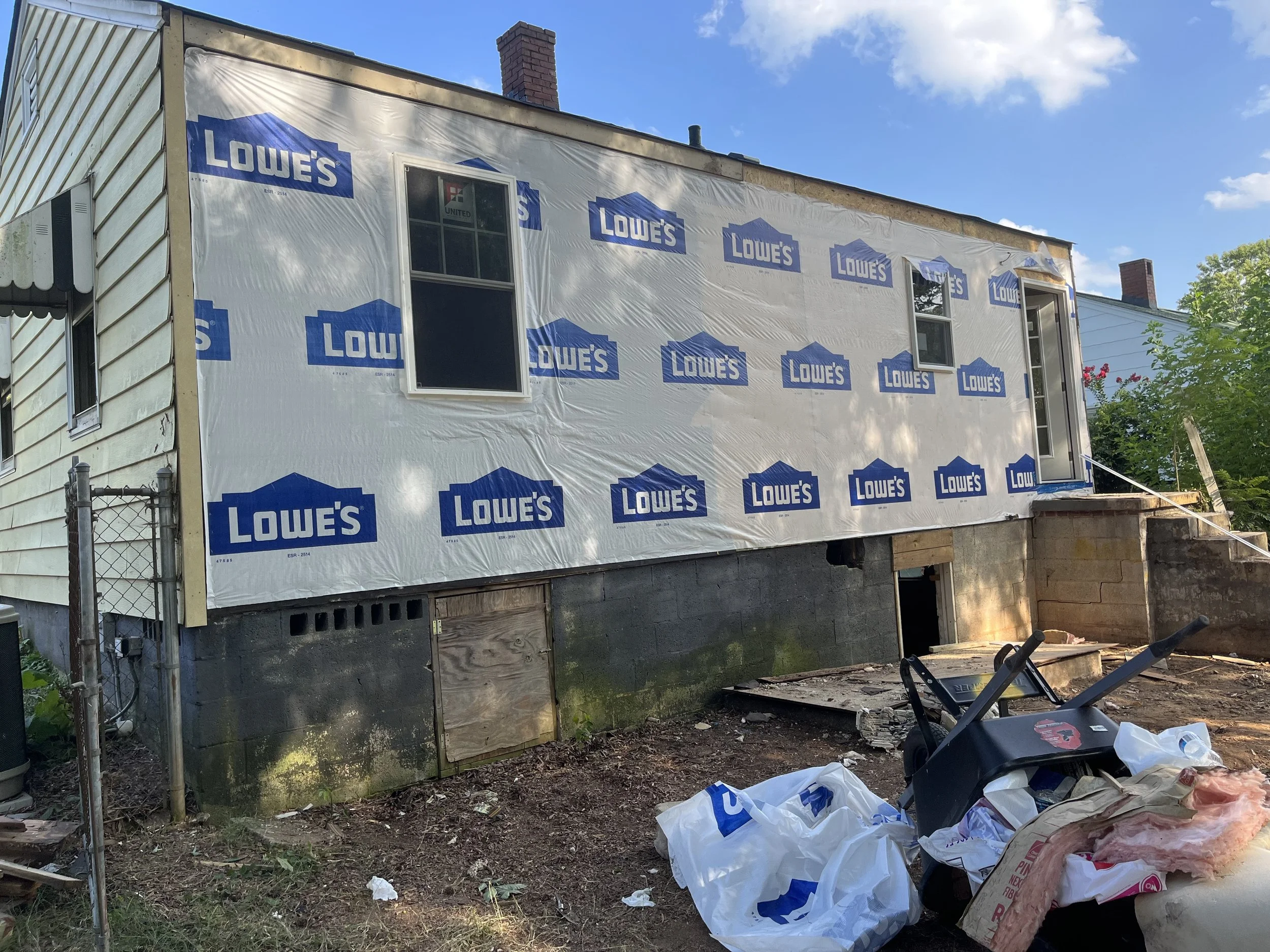  Finally, some house wrap after the new back wall was framed in. The sill plate and band had to be replaced as well as all framing, insulation, and siding. We took out the bathroom window and added back a window in the kitchen.  