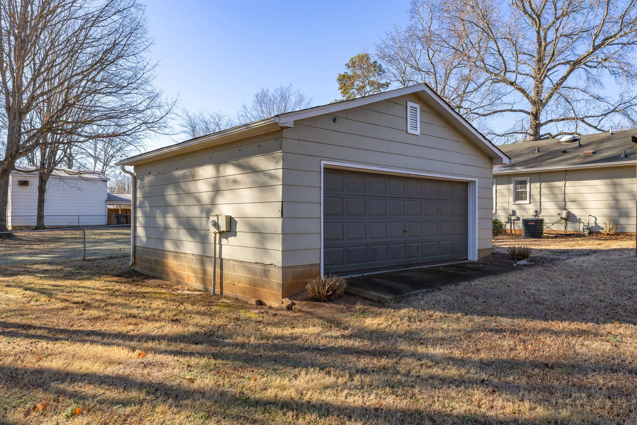 Rear access to oversized garage located behind the home