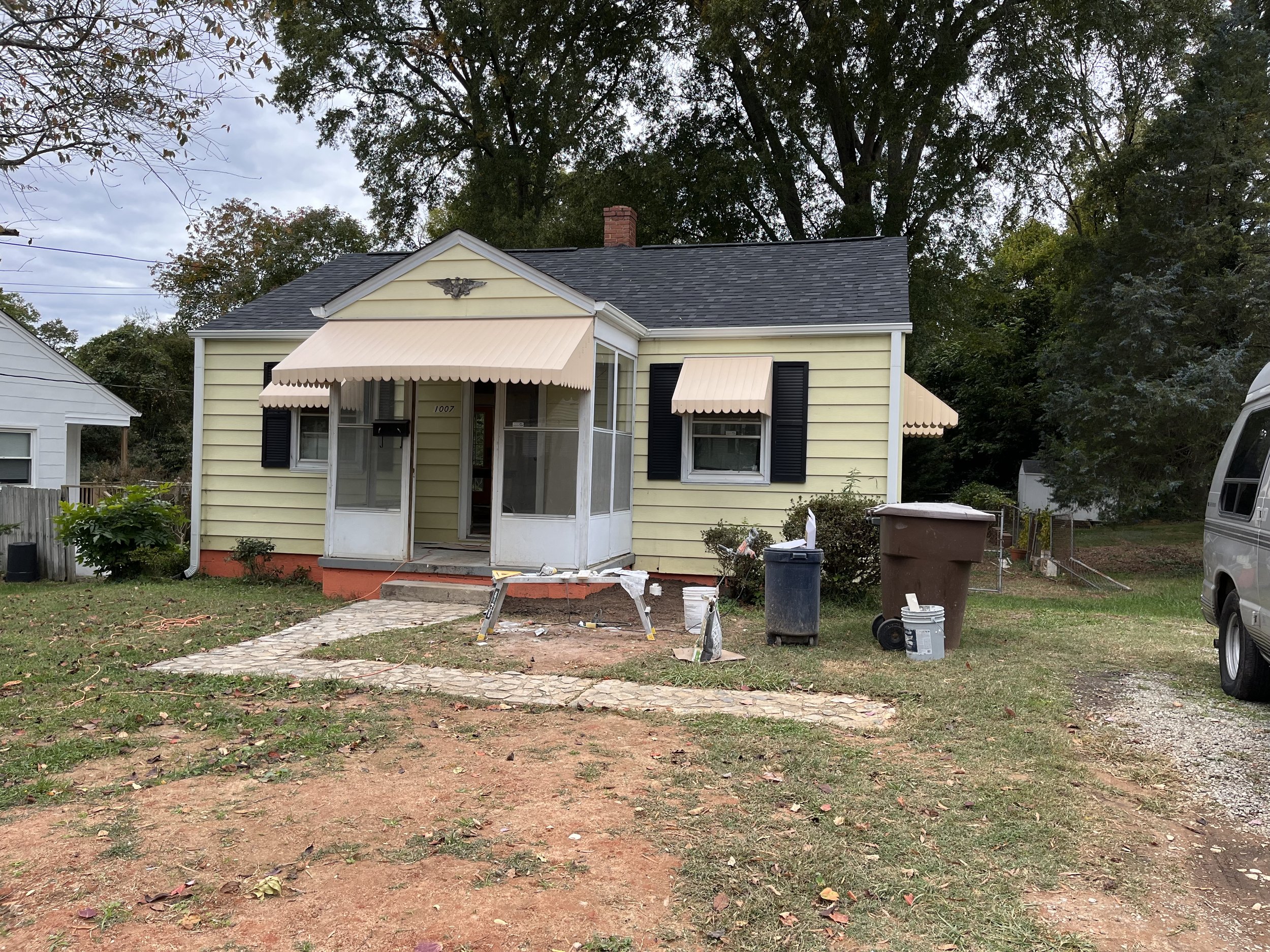 Vintage window awnings have been pressure washed and painted peach