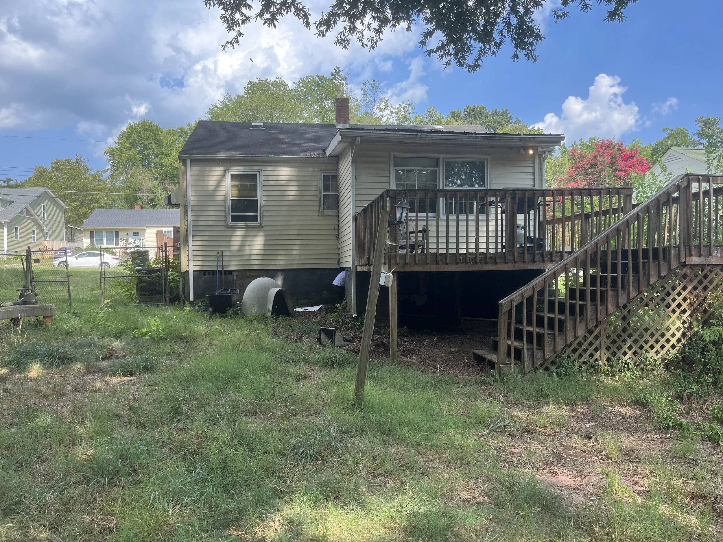  This is what the back of the house looked like when we first looked at the house. There was an addition on the back and a deck. Both were rotten.  