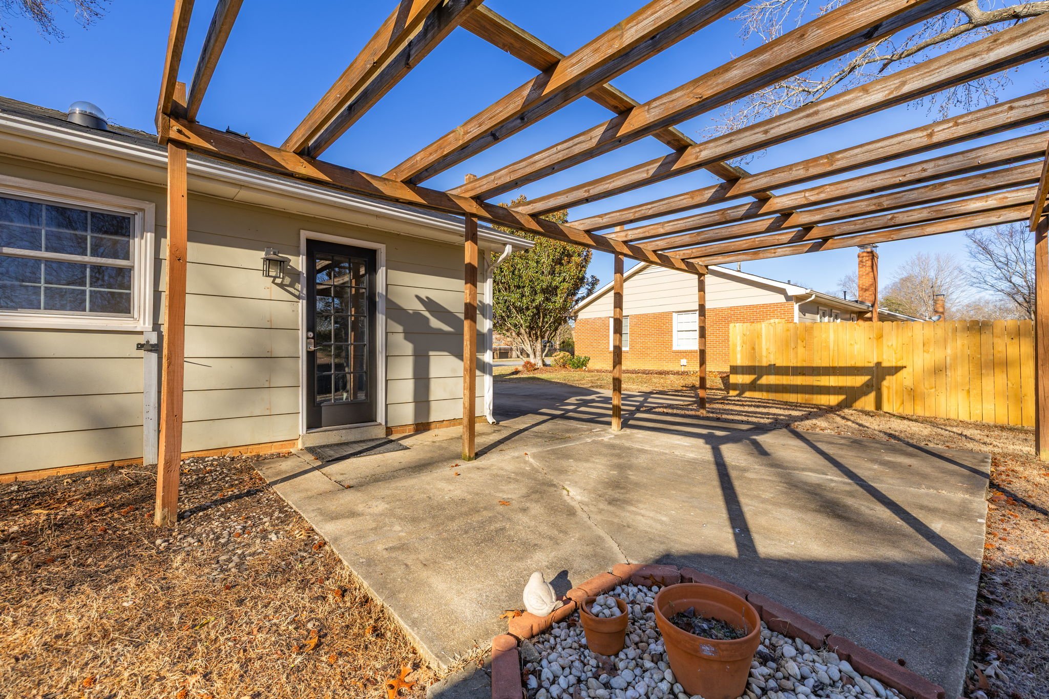 Rear exterior view of the home with private backyard space