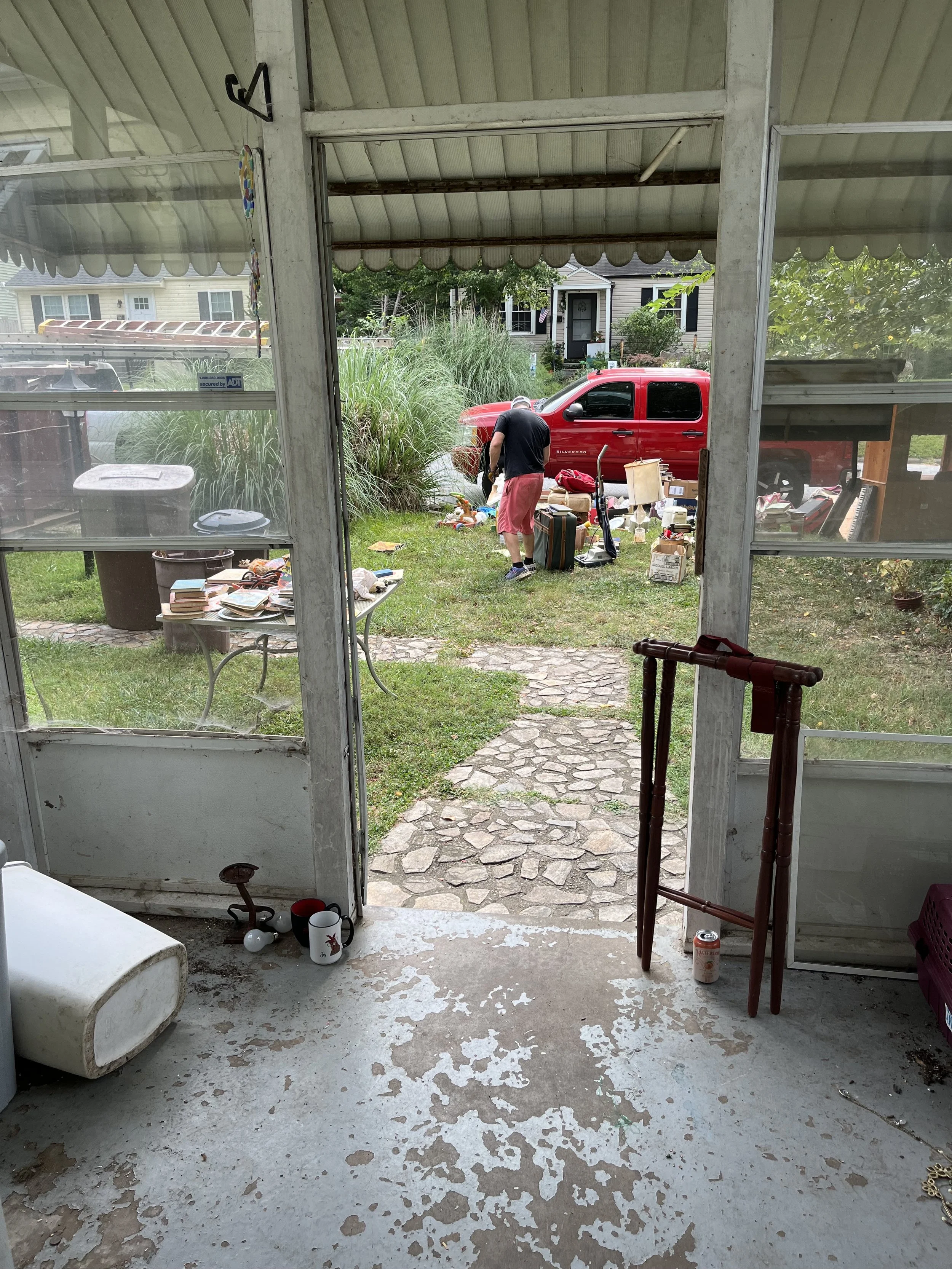  Looking out the front door from this small enclosed porch. I envision plants and a small bench or chair and way fewer spider webs.  