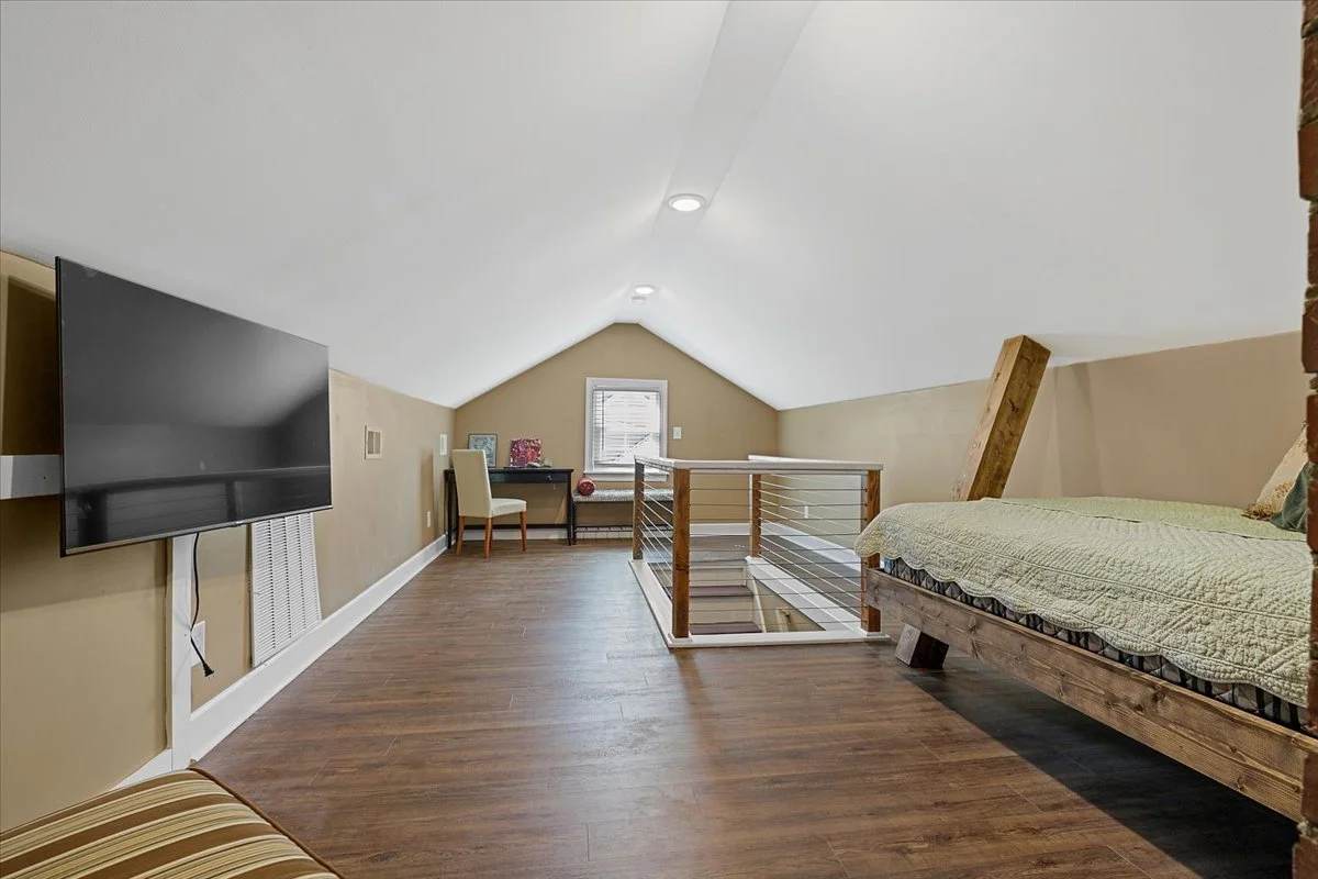 Upstairs bedroom with TV & office area