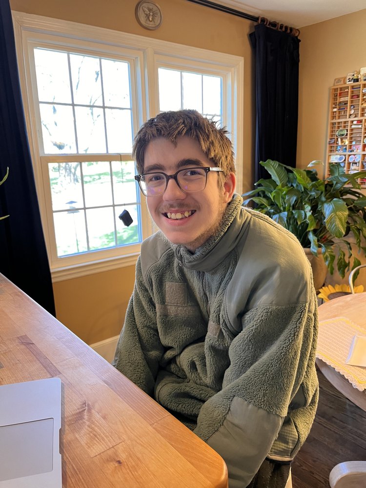 Josiah designing postcards in Canva, building technology skills