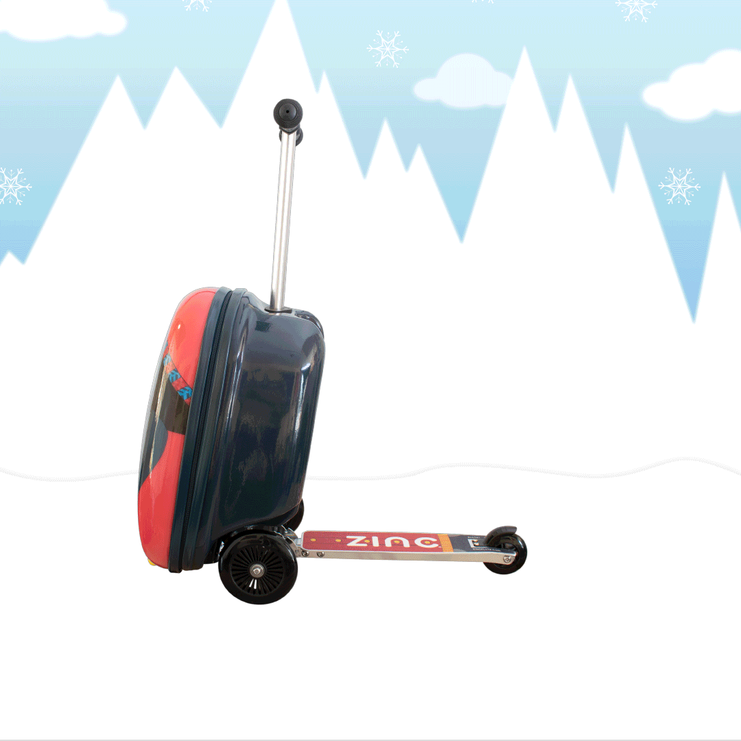 A children's suitcase on wheels with a handle, decorated with a cartoon character design, set against a wintery background with snowflakes and mountain silhouettes.
