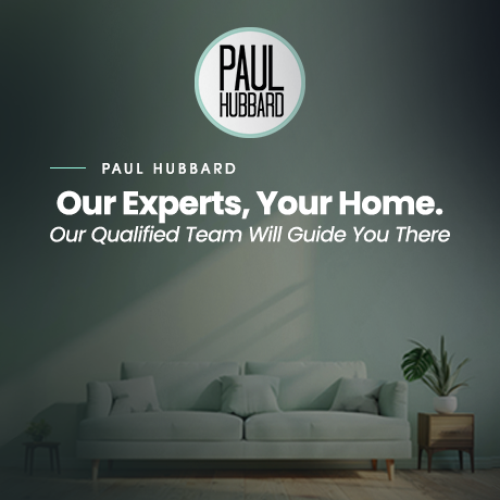 Logo for Paul Hubbard with the text "Our Experts, Your Home. Our Qualified Team Will Guide You There" over a living room with a white sofa, plant, and side table.