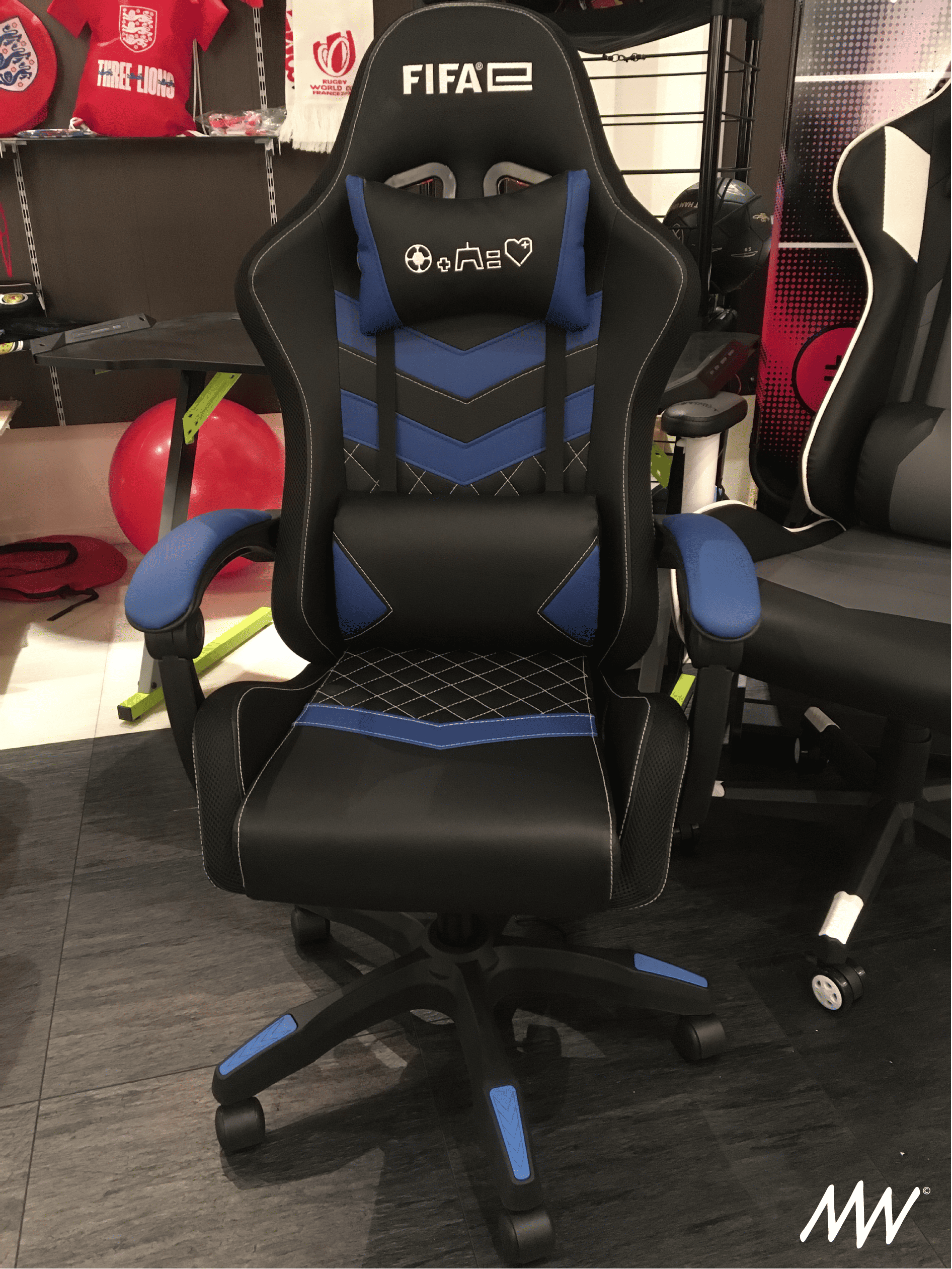 Black and blue gaming chair with a high back, armrests, and adjustable height.