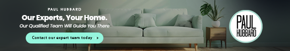 Living room with sofa, side table, lamp, and plant, advertisement for Paul Hubbard home experts