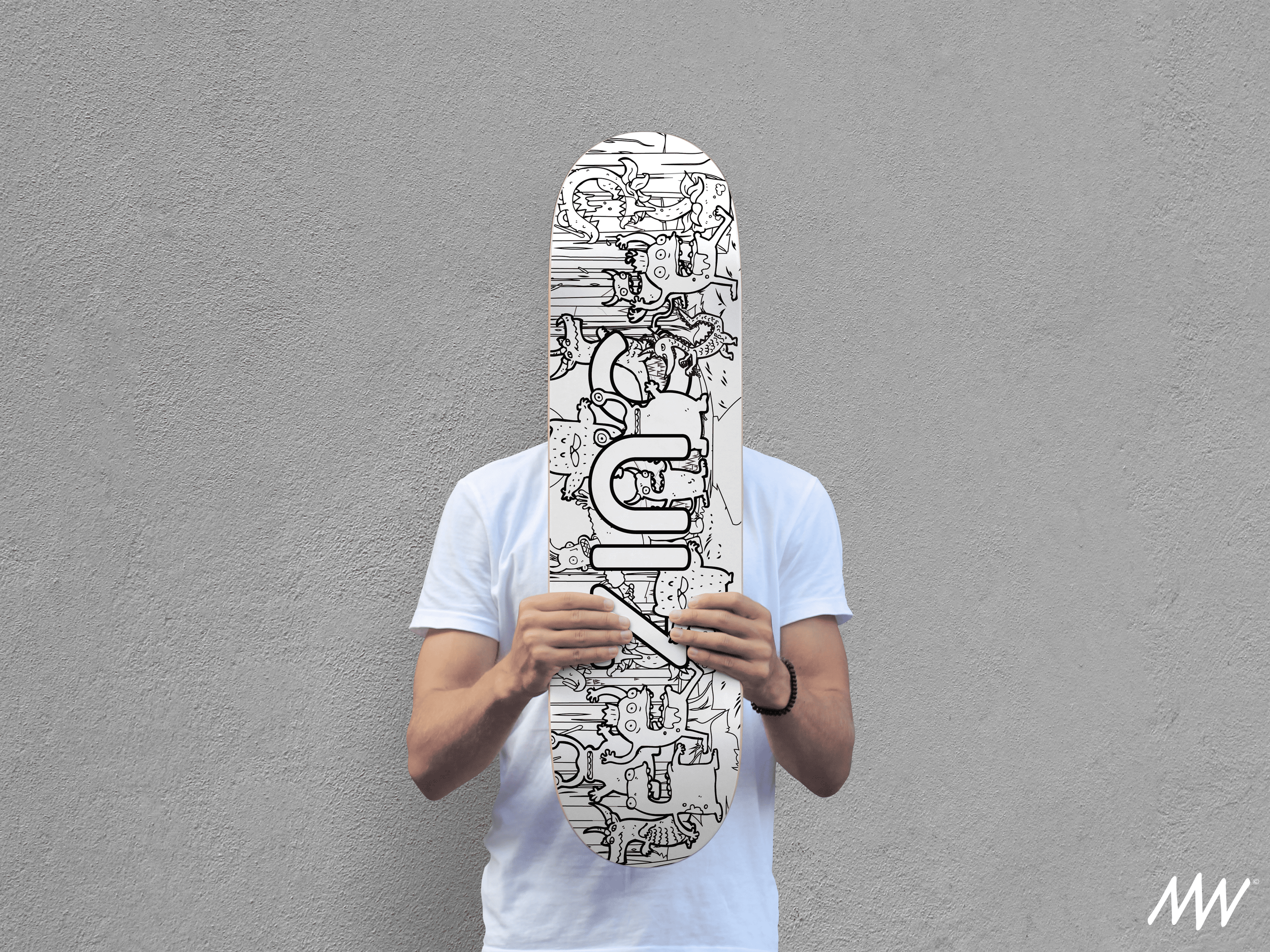 Person in a white t-shirt holding a black-and-white illustrated skateboard in front of their face, standing against a plain gray wall.