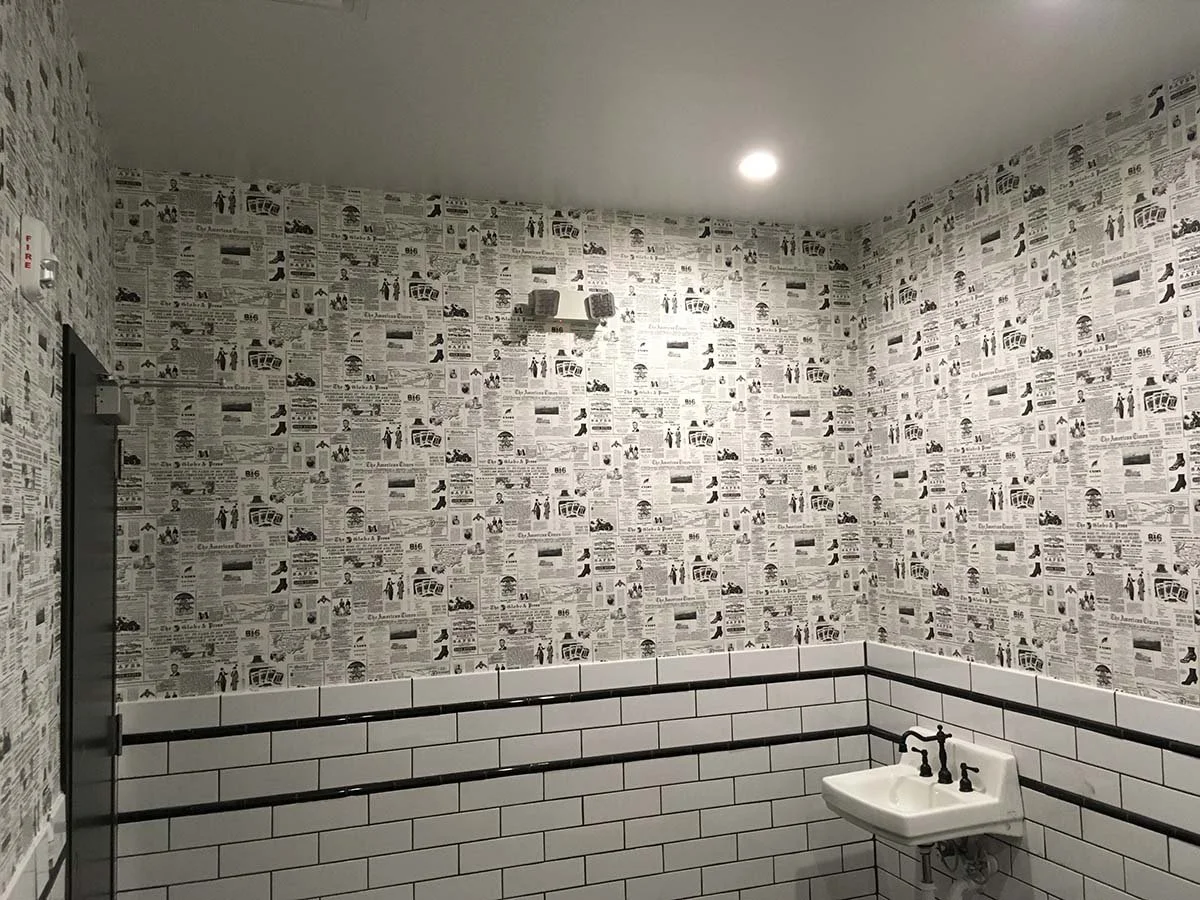 newspaper wallpaper hanging