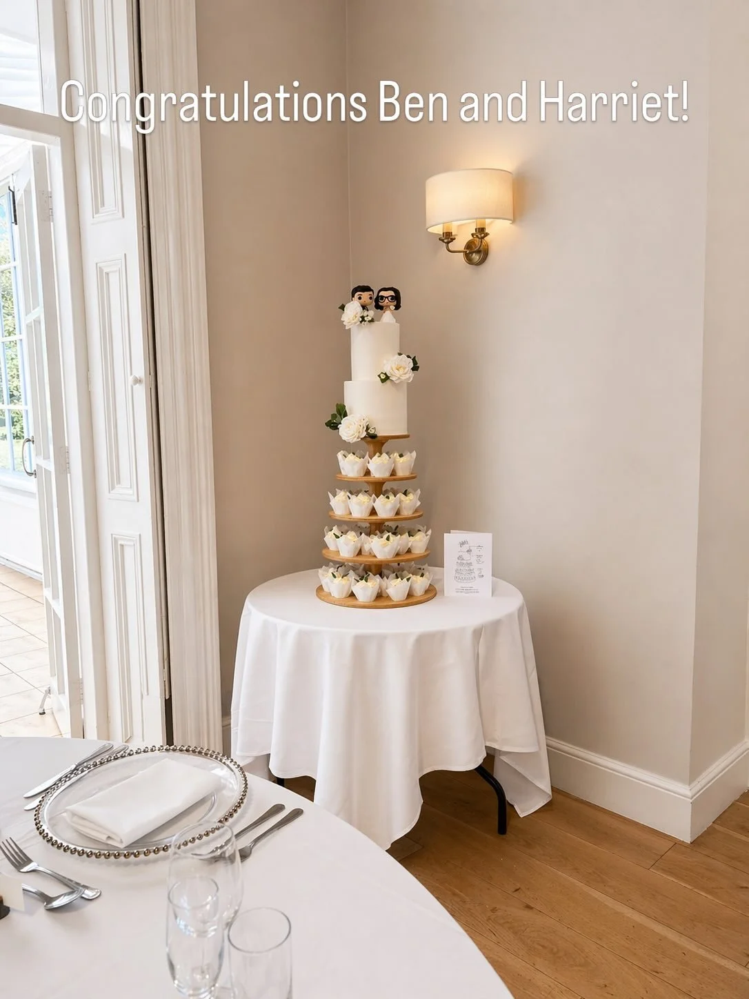 A beautiful set-up celebrating Ben &amp; Harriet 🤍

A classic two-tier cake paired with a cupcake tower, finished with soft ivory florals and a personal topper to bring everything together. Simple, elegant, and perfect for the space.

Wishing you bo