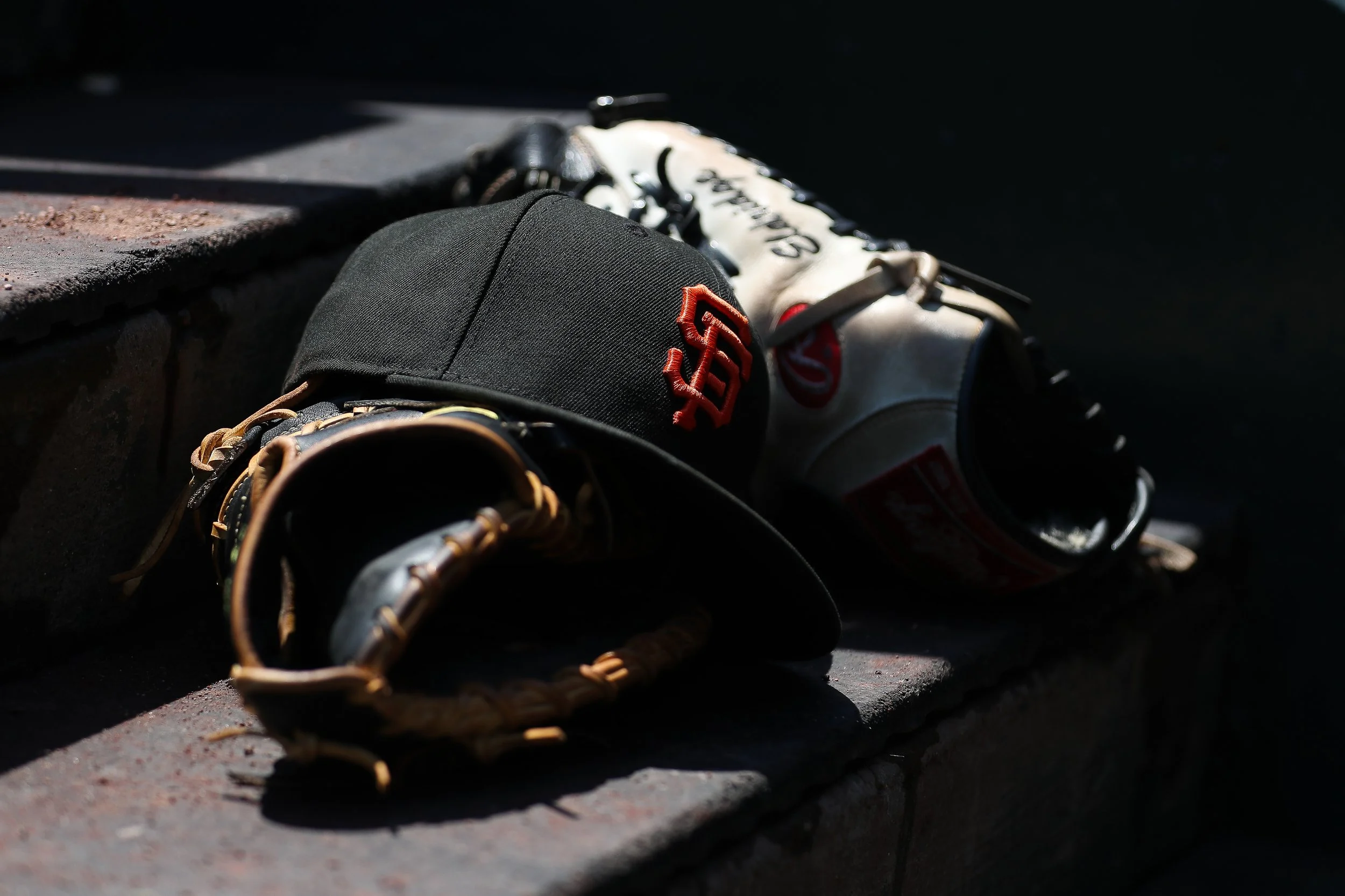 May 6, 2026; San Francisco, California, USA; A hat and glove used by a San Francisco Giants player sits on the step before a baseball game against the San Diego Padres at Oracle Park. Mandatory Credit: Scott Marshall-Imagn Images