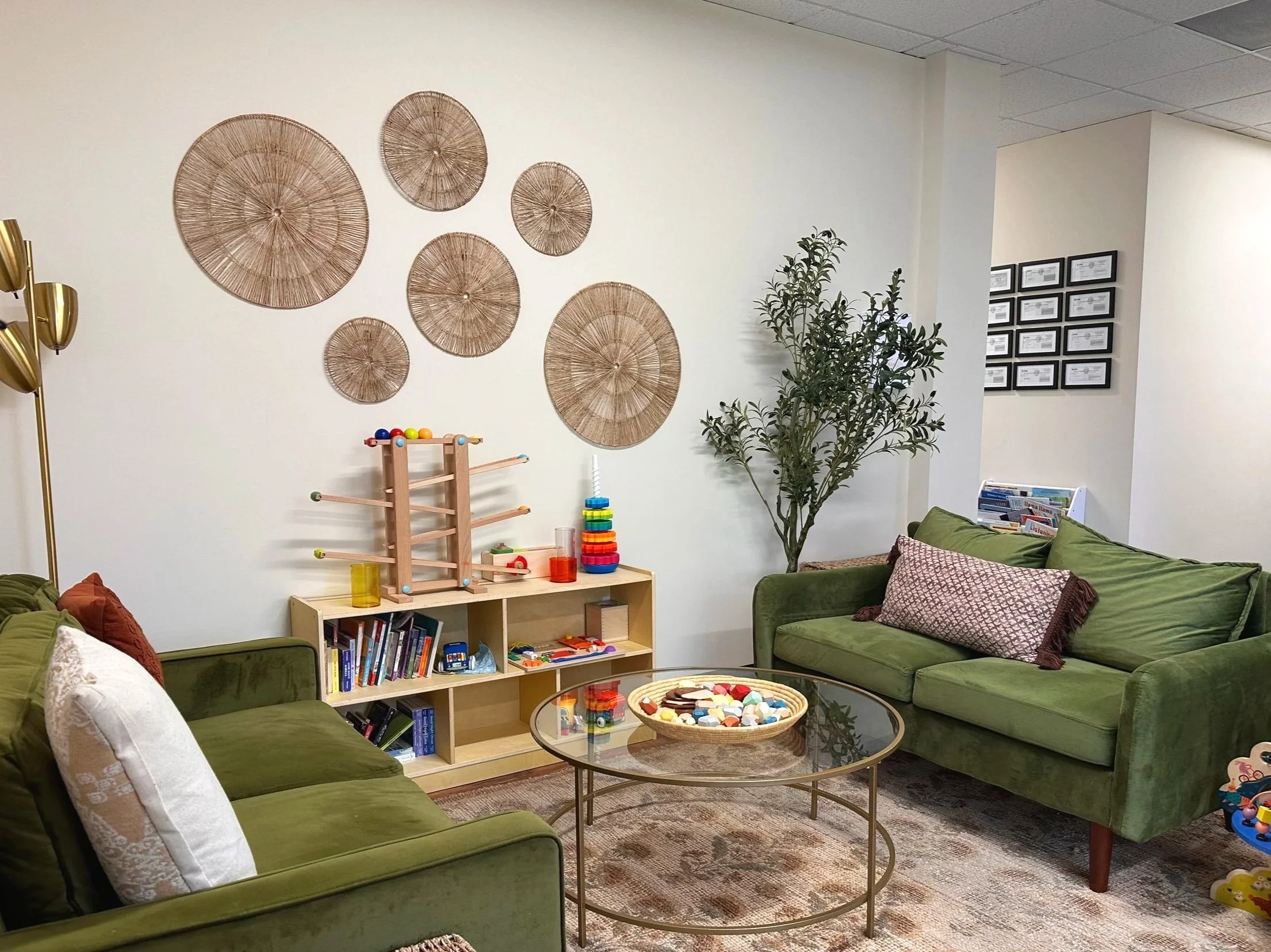 Siblings and parents have their own cozy corner to read, build, and decompress while sessions are in progress.