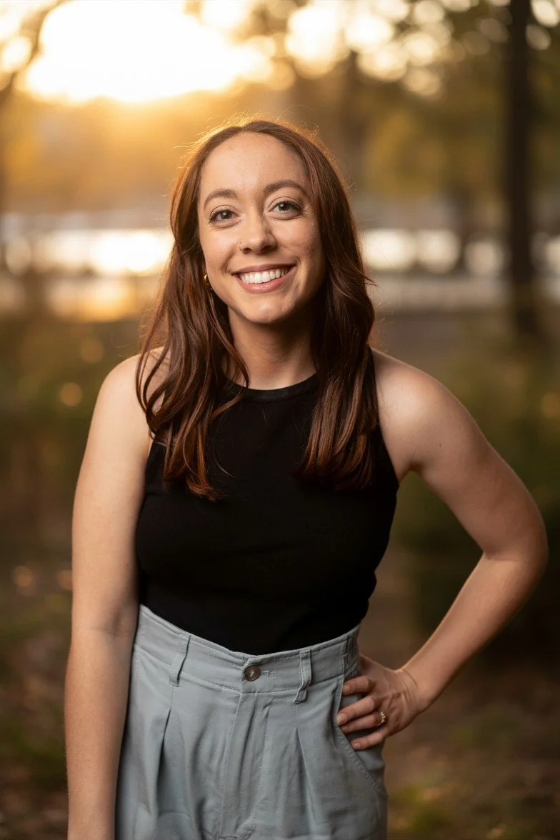 Therapist smiling in a studio portrait representing parenting support for families in Oakland.
