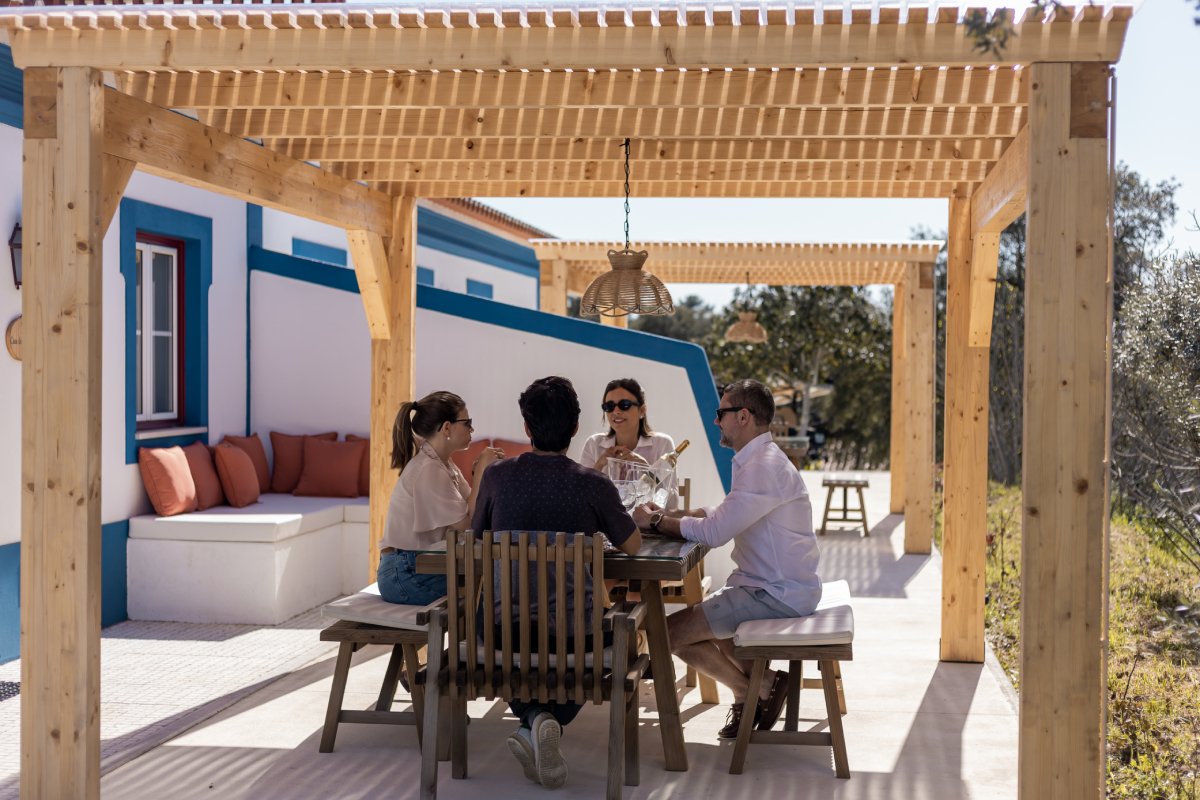 Family enjoying lunch on a terrace at the equestrian resort in Portugal