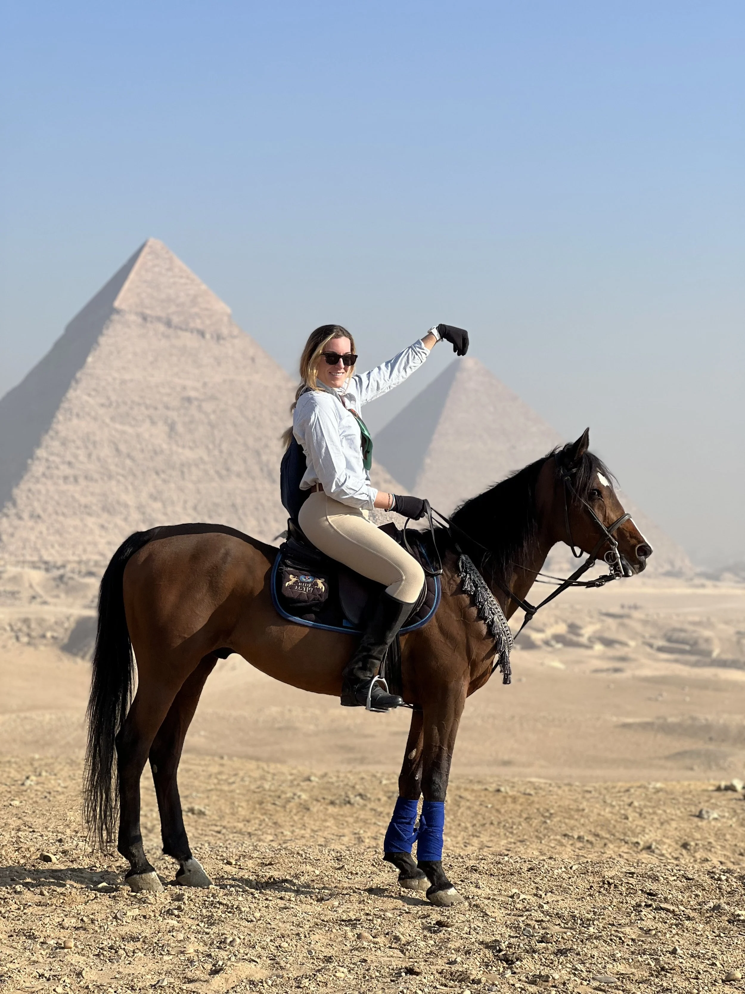 Ride horses in front of Cairo's iconic pyramids
