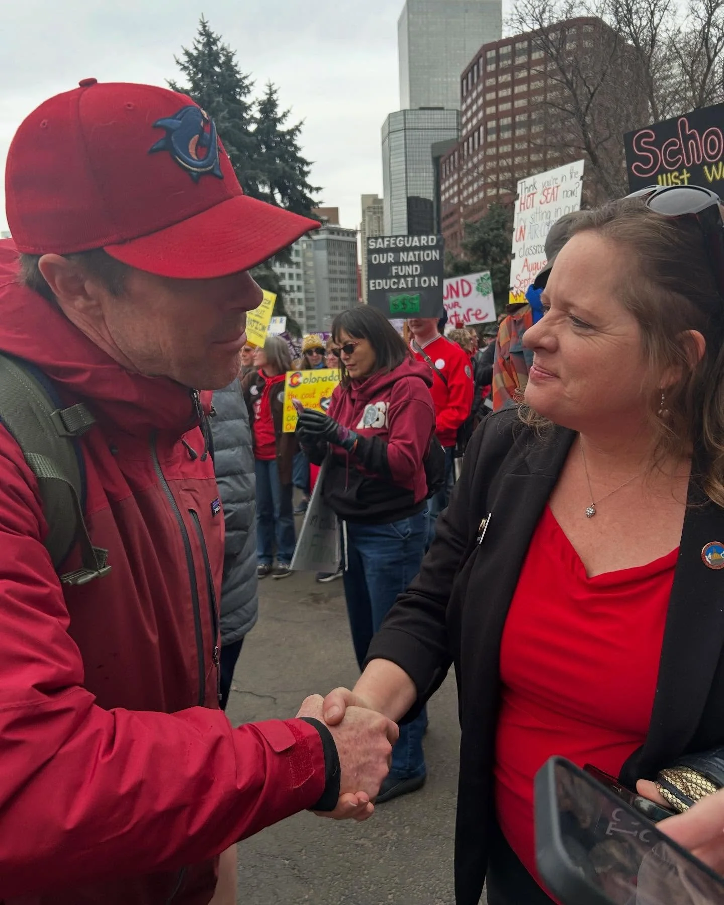 Janice Marchman speaks with a education worker at the teachers union protest