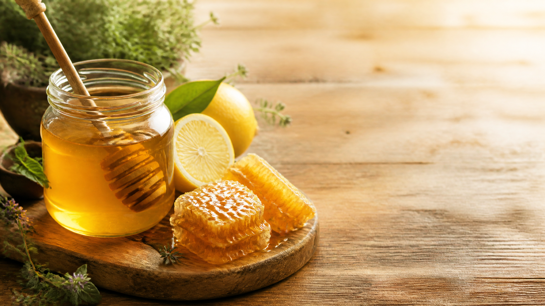 Jar of raw honey with honeycomb, lemon and herbs — Art of the Hive