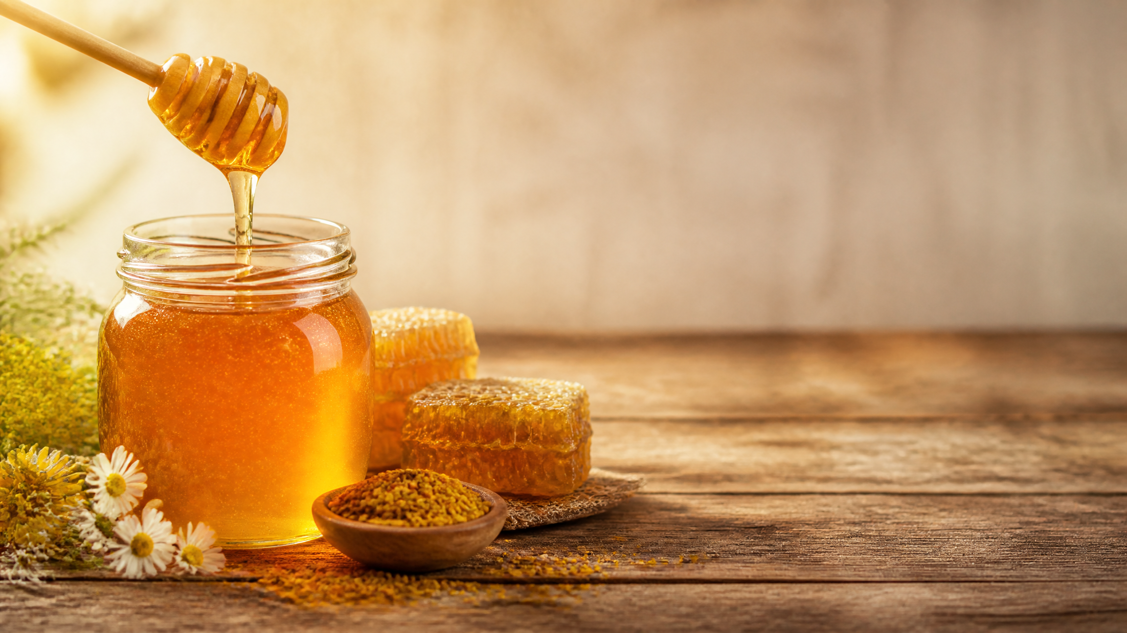 Jar of raw Australian wildflower honey with a wooden dipper, honeycomb and bee pollen — Art of the Hive