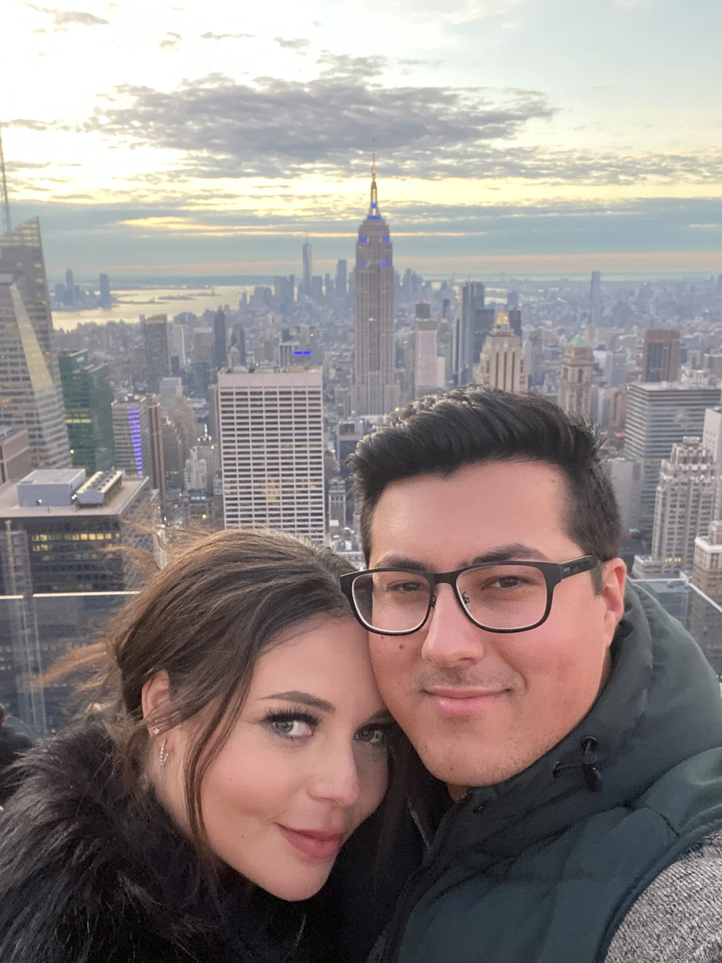 two people with nyc empire state building