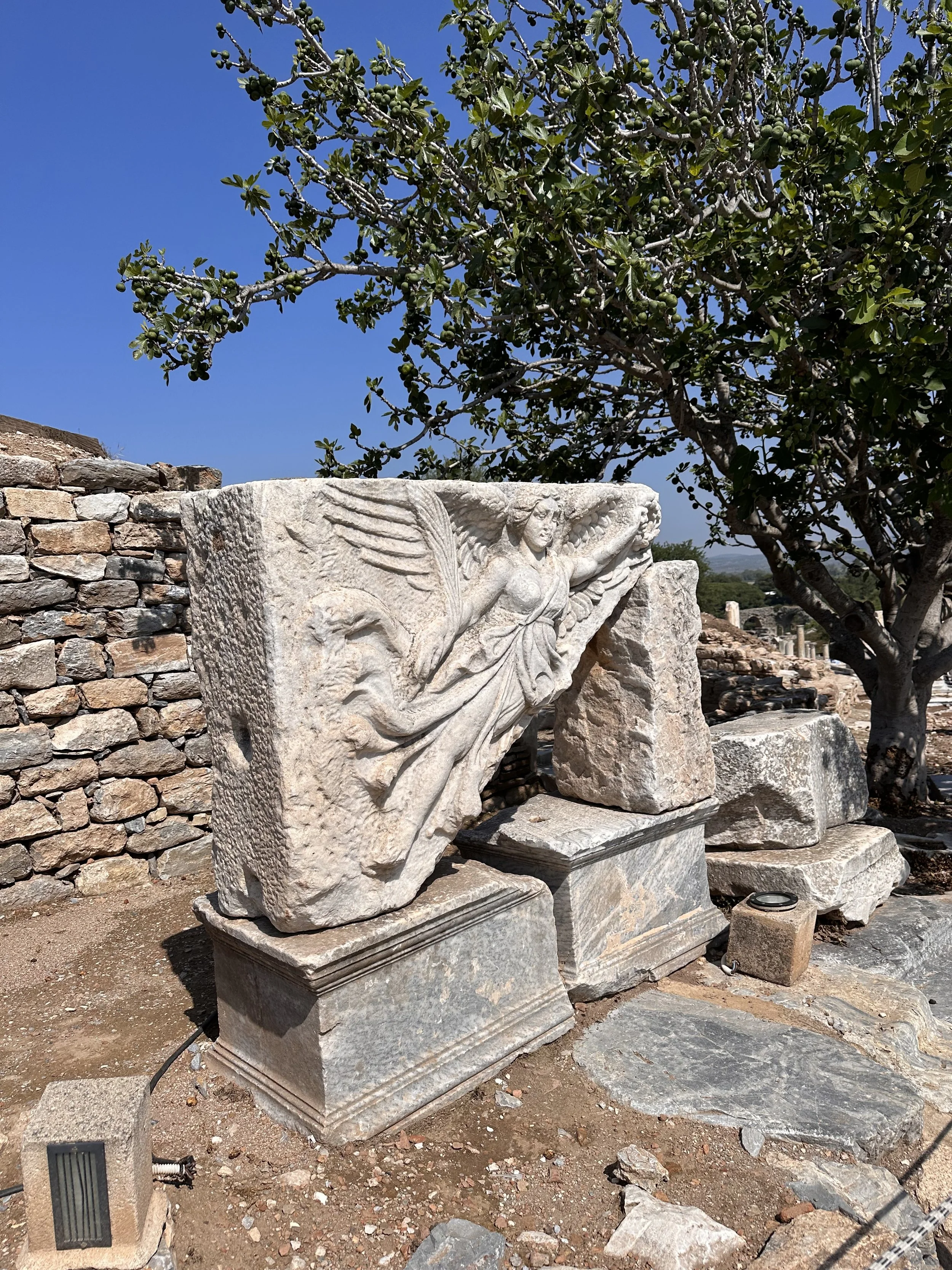 marble relief carving of the winged goddess Nike
