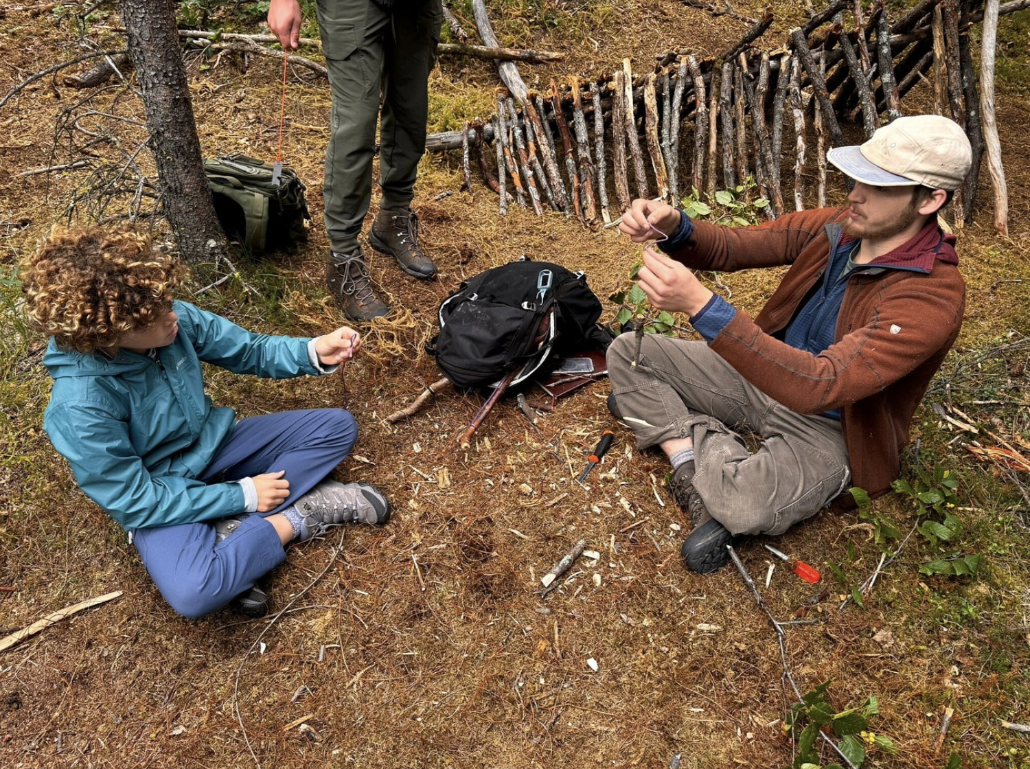 Family practicing survival skills and having fun on a 4-Hour Denali Survival Tour.