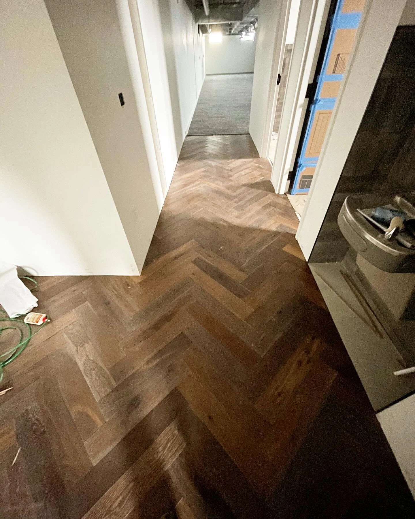 Just finishing up this herringbone. Although beautiful wood was used, I would recommend a lighter wood like maple, or aspen- or a warm toned neutral stain to bright up and widen this hallways. #herringbonefloor #utahwoodworker