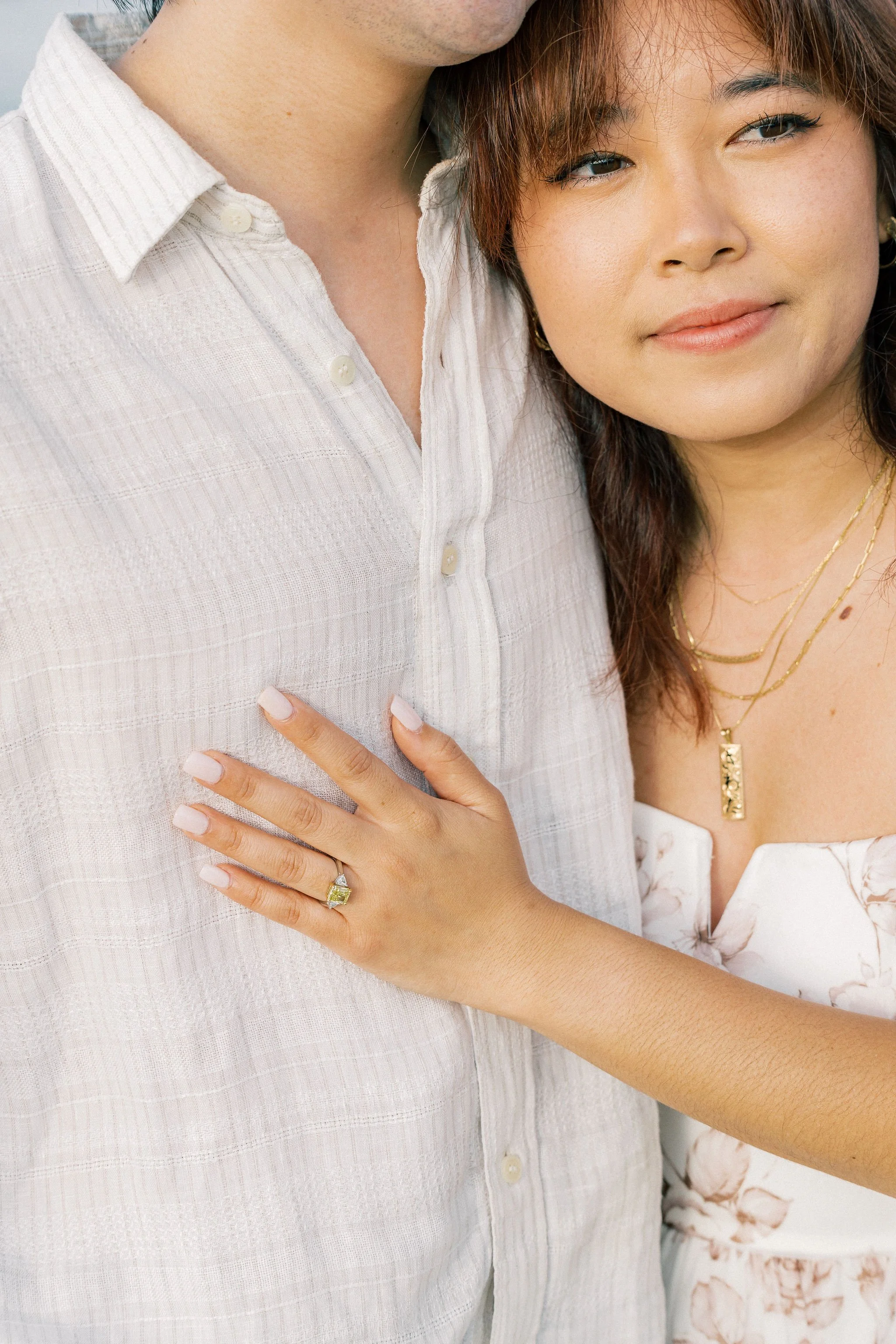 Close up shots of surprise engagement photography in Maui, Hawaii with tropical floral leis and just engaged couple photographed on digital and film photography by Maui based wedding photographer, Lesley Castle Photo.
