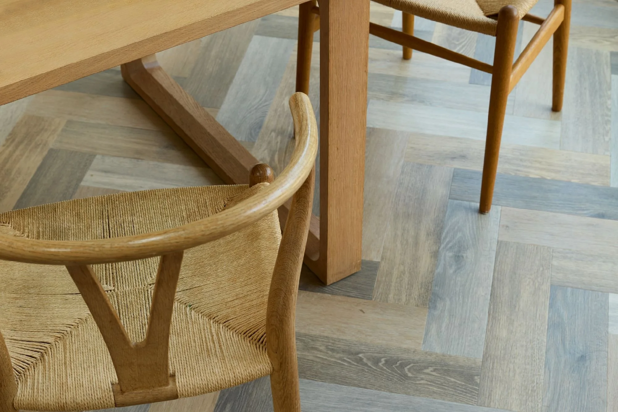 Rustic dining area with wooden furniture, gray-tiled accent floor, and black-framed windows