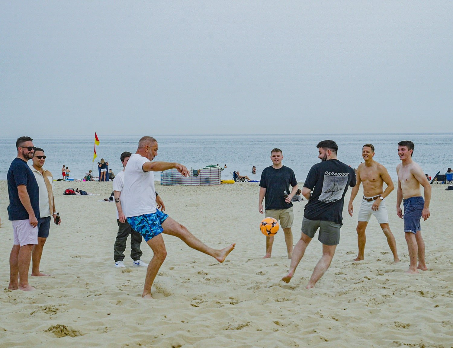 Andy Strong playing football at sandbanks beach
