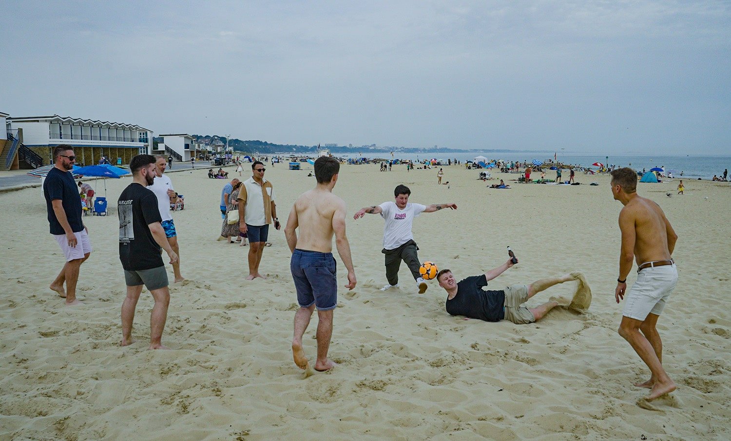 The oakstone team playing football at sandbanks beach