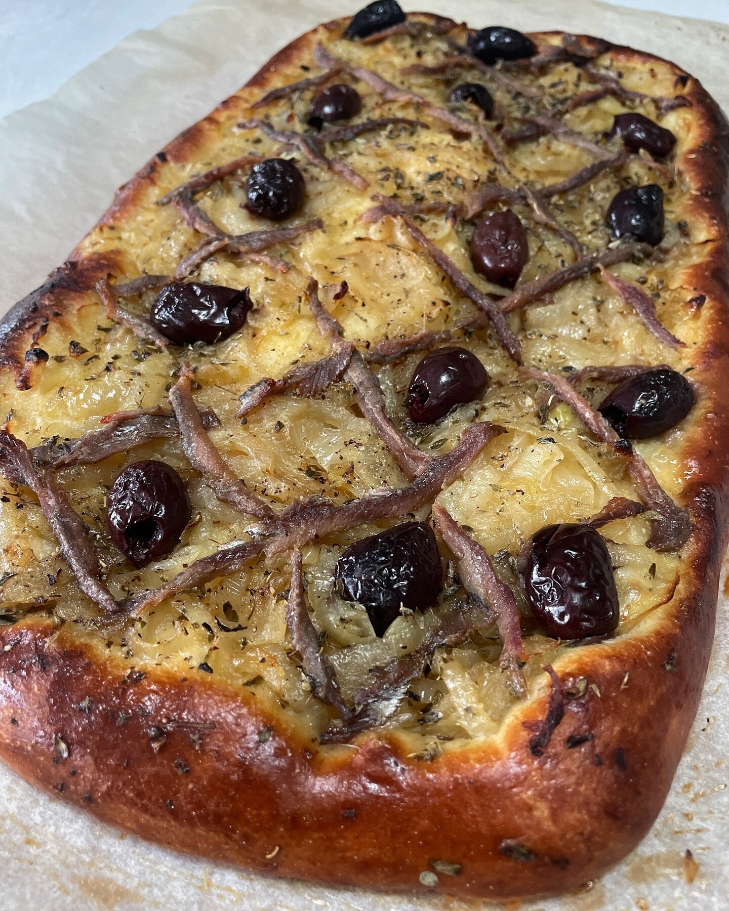 Brioche tart with meltingly soft and sweet braised onions, salty slivers of anchovy&rsquo;s , kalamata olives and  herbe de Provence. 
I love the versatility of brioche - robust enough to support a fairly hefty level of topping as a tart base yet sti