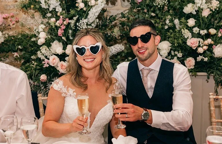 ✨ Top table goals ✨
Heart-shaped sunnies, glasses of fizz and the dreamiest floral backdrop 🌸🥂

@mariamadisonphotography 

#wickfarmweddings #toptablegoals #barnwedding #weddingdaydetails #ukweddingvenue #weddinginspo #floraldreams #tablescape #bar