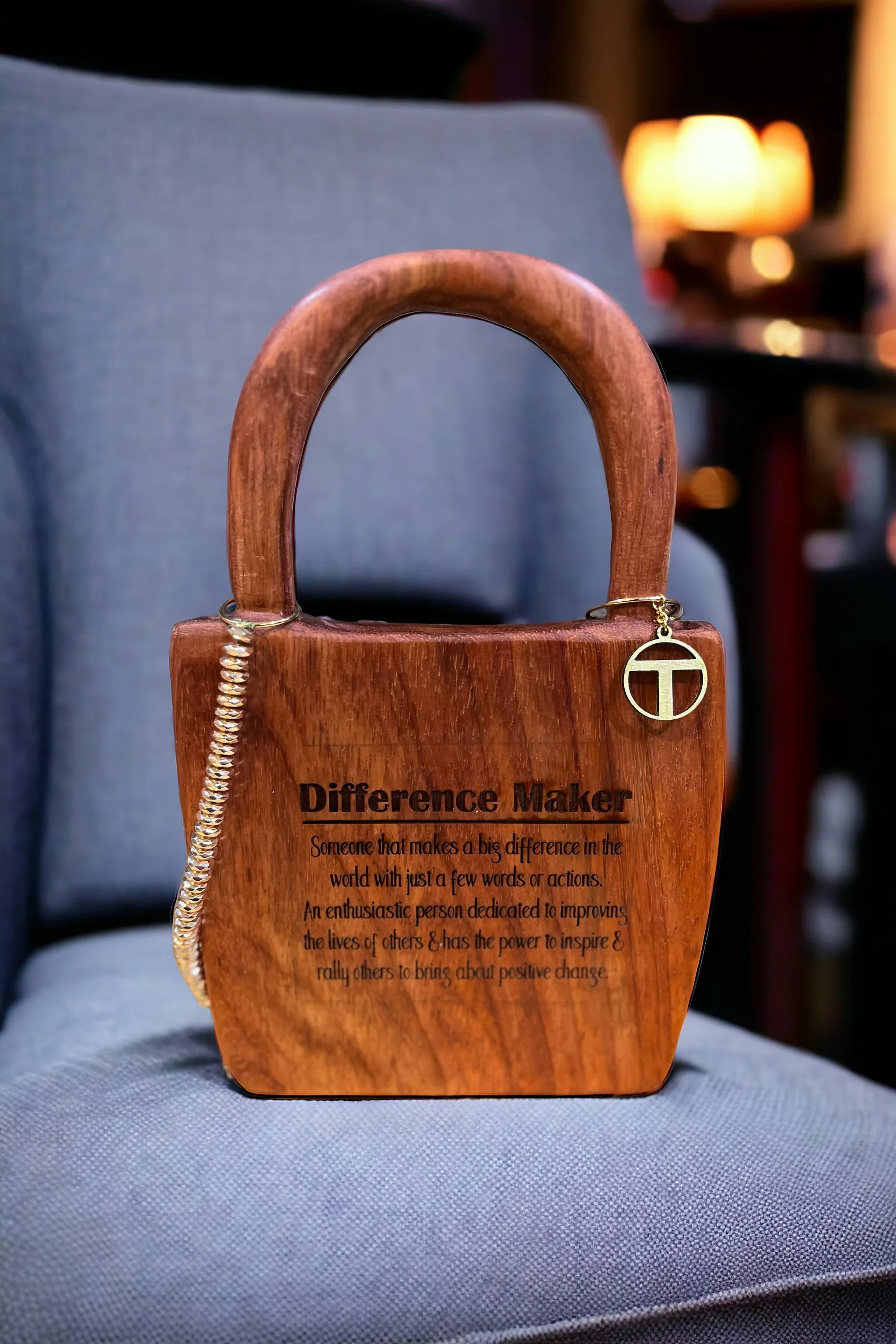 Image of a wooden handcarved purse with an inspirational saying engraved on it